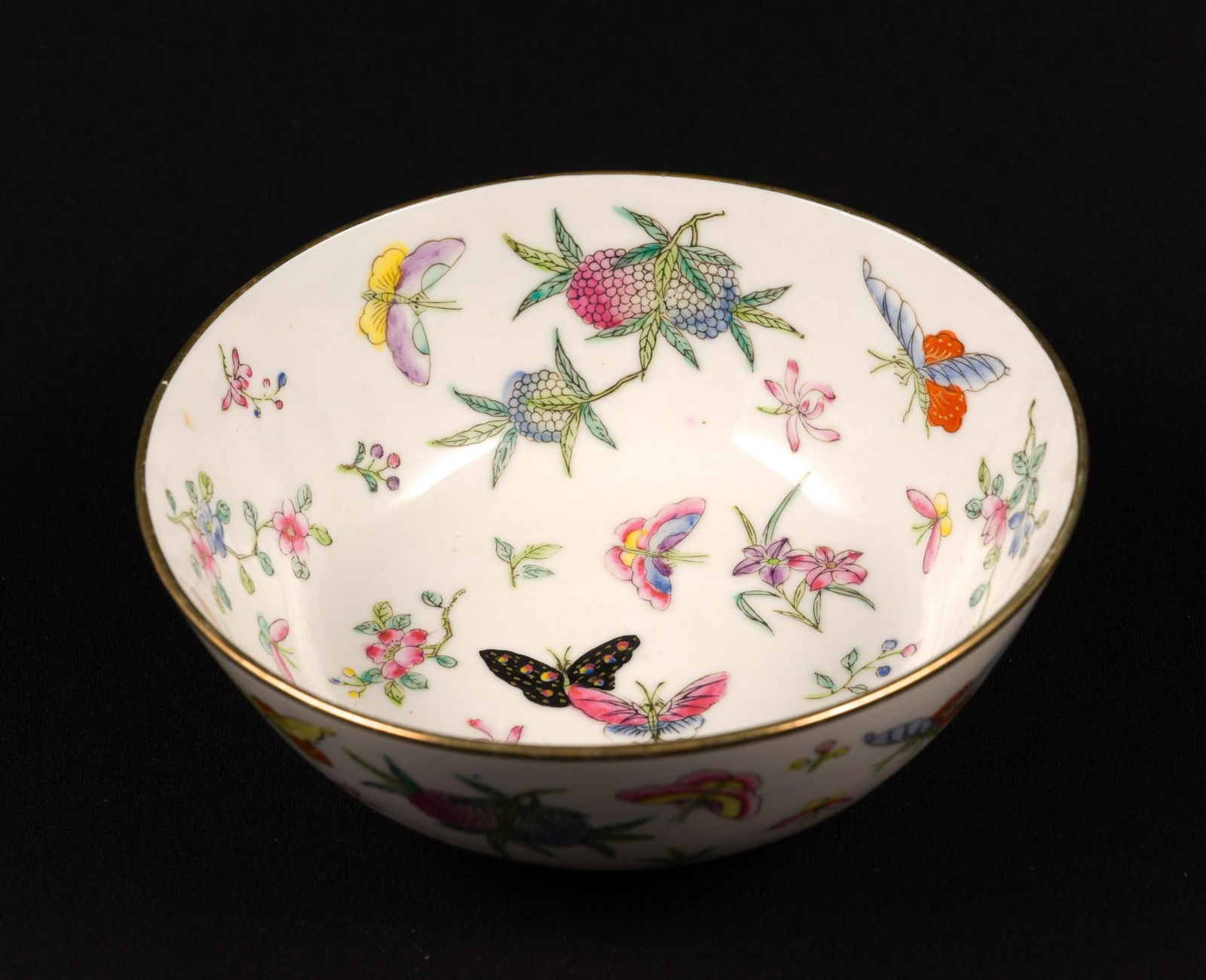 Asian Bowl: Floral and butterfly decoration. Bottom stamped. Bottom marked " Japan China Decorated in Hong Kong." 7-1/4" wide x 3" high.