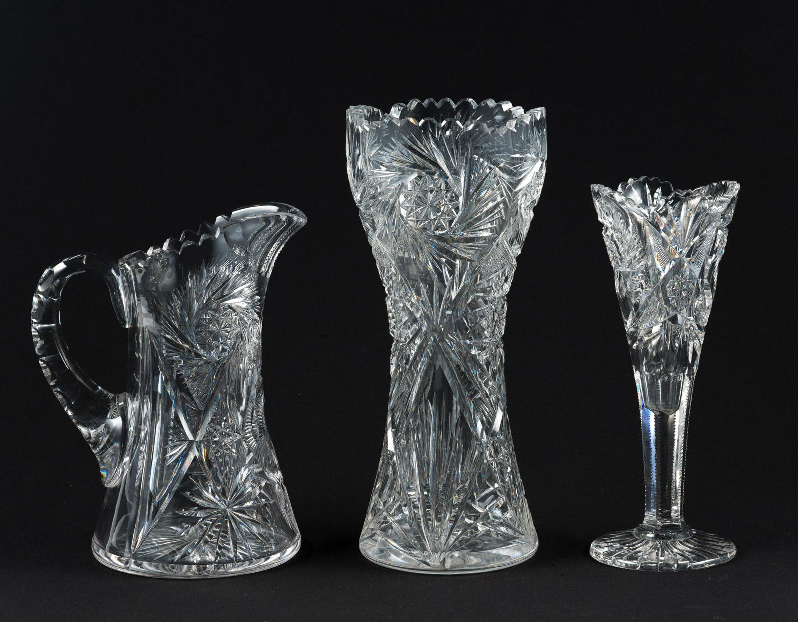 2 Cut Glass Vases & Cut Glass Pitcher: No maker's marks. 5" to 6" wide x 9-1/4" to 12" high.