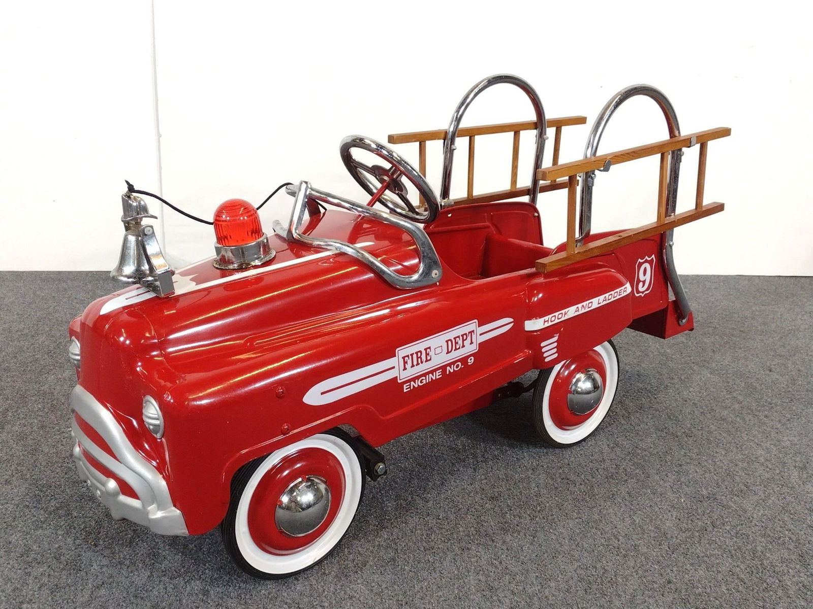 Children's Fire Dept Engine No. 9 Firetruck Peddle Car: NOT ELIGIBLE FOR IN-HOUSE SHIPPING: See Terms for Shipping Options. Marked Fire Dept Engine No. 9 on side. With original ladders. One ladder is missing a rung. 14" wide x 42" long x 24" high.