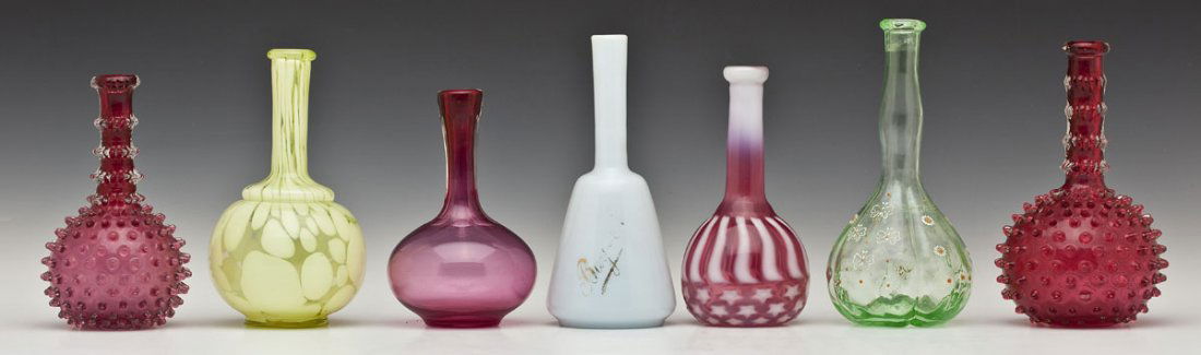 7 19th C Glass Barber Bottles: DESCRIPTION: Seven glass barber bottles including: 1) Cranberry hobnail bottle. Smooth pontil. 7" high. 2) Cranberry hobnail bottle. Smooth pontil. 8" high. 3) Cranberry stars and stripes bottle. Smoo