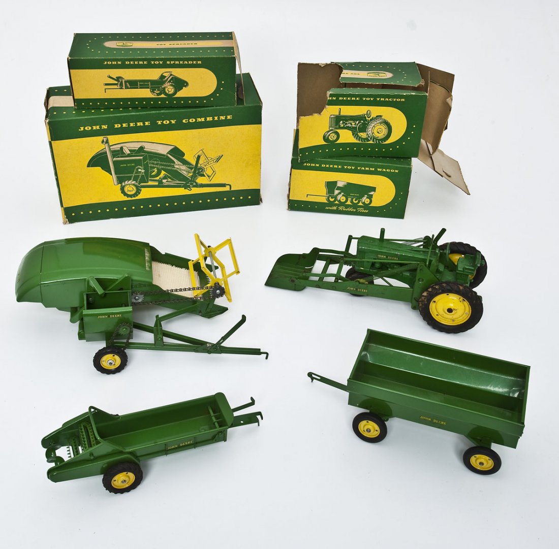 4 Eska John Deere Pressed Steel Farm Toys: DESCRIPTION: Four Eska John Deere green painted pressed steel farm toys in their original boxes. Each marked "John Deere," in yellow on either side of toy and with yellow hubcaps and rubber wheels. In