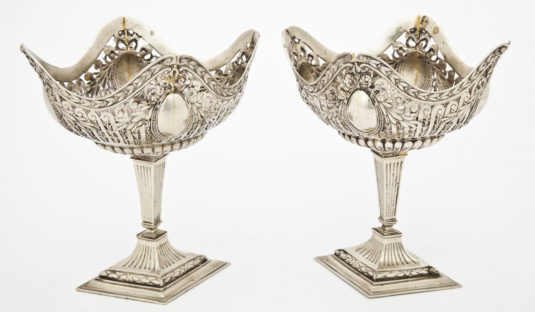 Pair of Continental Silver Plate Compotes: DESCRIPTION: Pair of Continental silver plate compotes. Reticulated bowls with scalloped rims and decorated overall with laurel swags and garlands on ribbed diamond shaped bases. 19th century. MEASURE