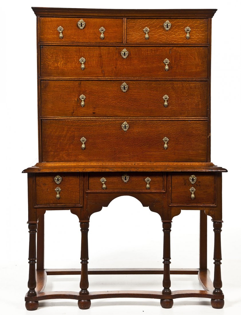 English William & Mary Two Part Highboy: DESCRIPTION: A William and Mary two part highboy. The top with straight cornice over two drawers over three single drawers. The base with three graduated drawers over a carved and arched skirt, turned