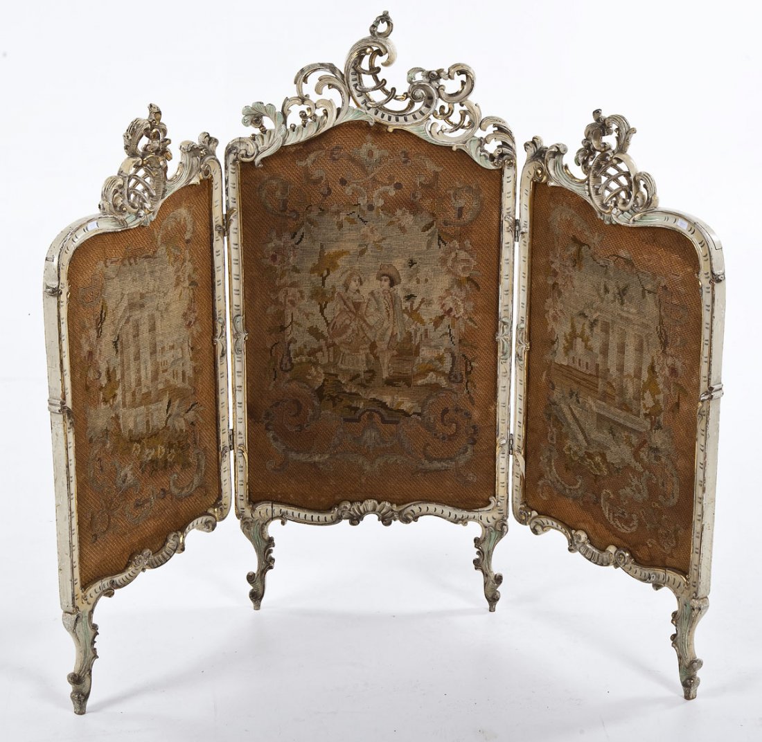 French Needlepoint Firescreen: DESCRIPTION: French needlepoint firescreen with a white and gilt painted wood scroll frame with four feet and embroidered panels. Center panel depicting a vignette of a couple and the side panels depi
