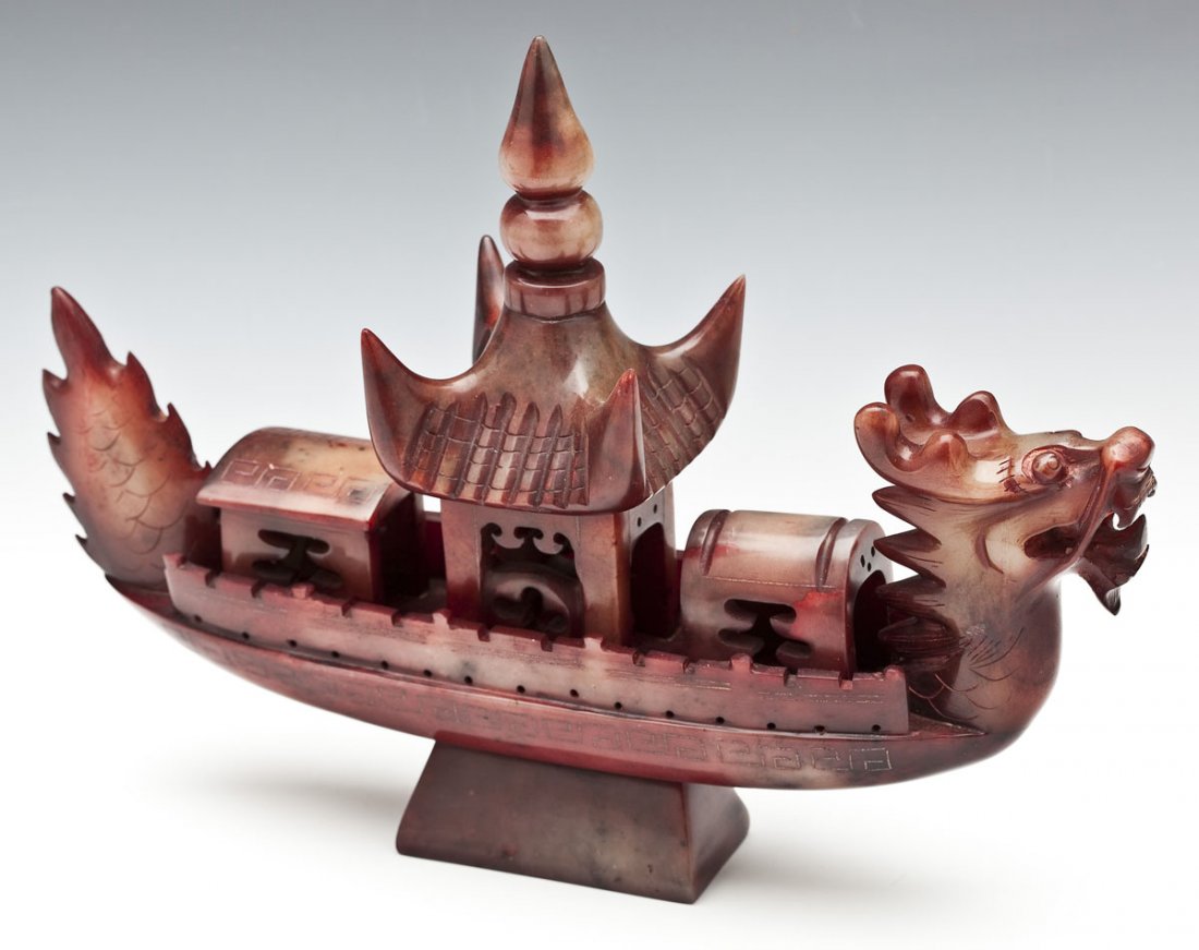 Chinese Carved Red Jade Dragon Boat: DESCRIPTION: Chinese carved red jade dragon boat with a dragon head at the front and a pagoda type building in the center. With etched decoration. MEASUREMENTS: 10" x 14" x 2-3/4". CONDITION: No defec