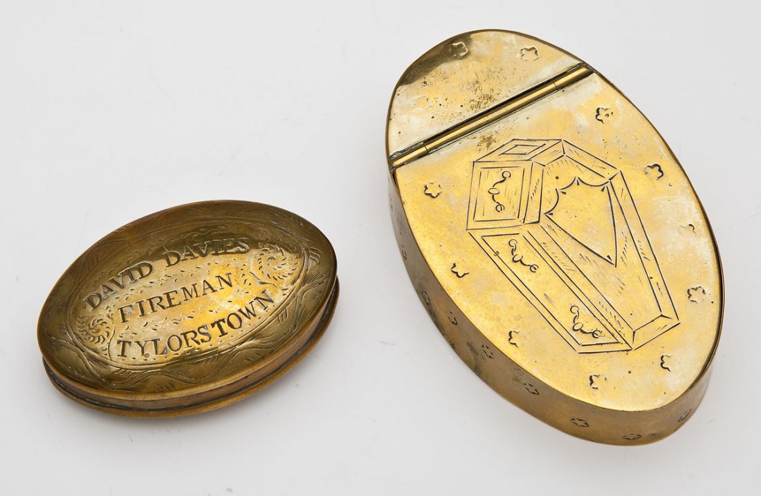 2 19th C Brass Tobacco & Snuff Boxes: DESCRIPTION: Two 19th century brass tobacco and snuff boxes. Includes: 1) Dutch tobacco box with an engraved design of a coffin bordered by stars. Hinged at the top. 1" x 4" x 2-1/2". 2) Tylorstown, W