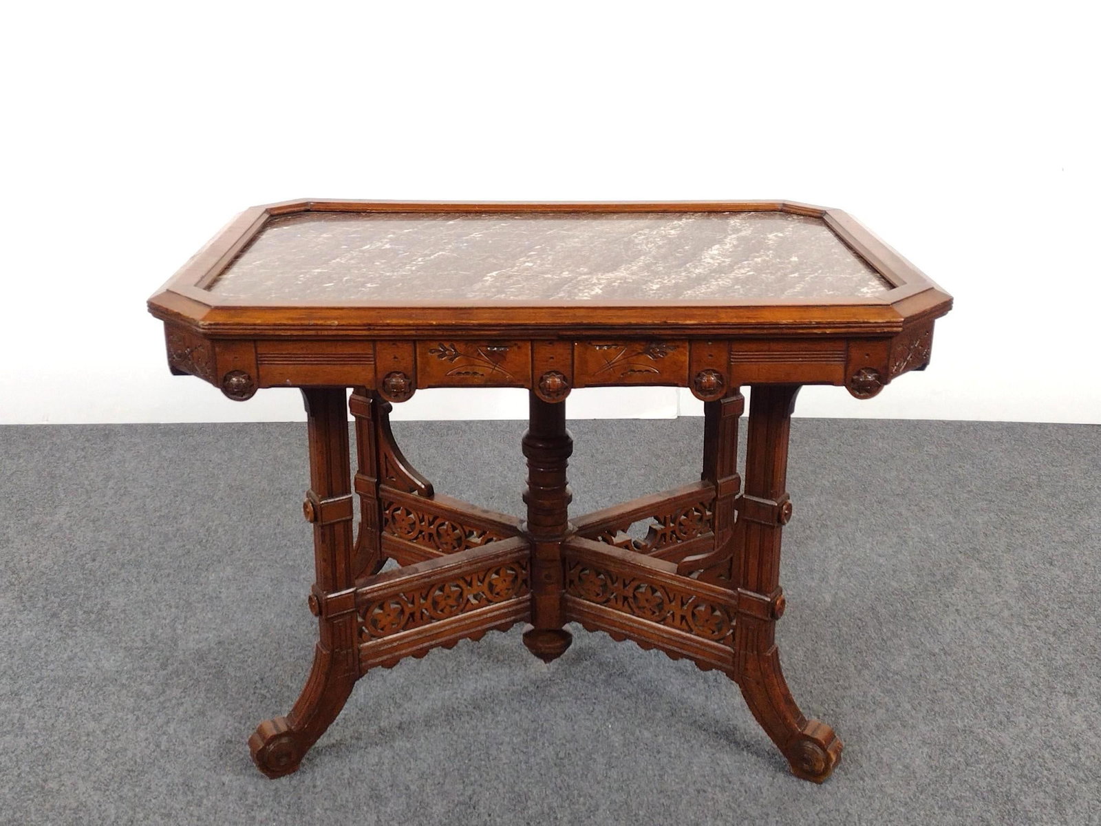Antique Victorian Marble Top Carved Parlor Table: NOT ELIGIBLE FOR IN-HOUSE SHIPPING: See Terms for Shipping Options. 37" wide X 25" deep X 27" high has some light scratches. Has area of loss on base.