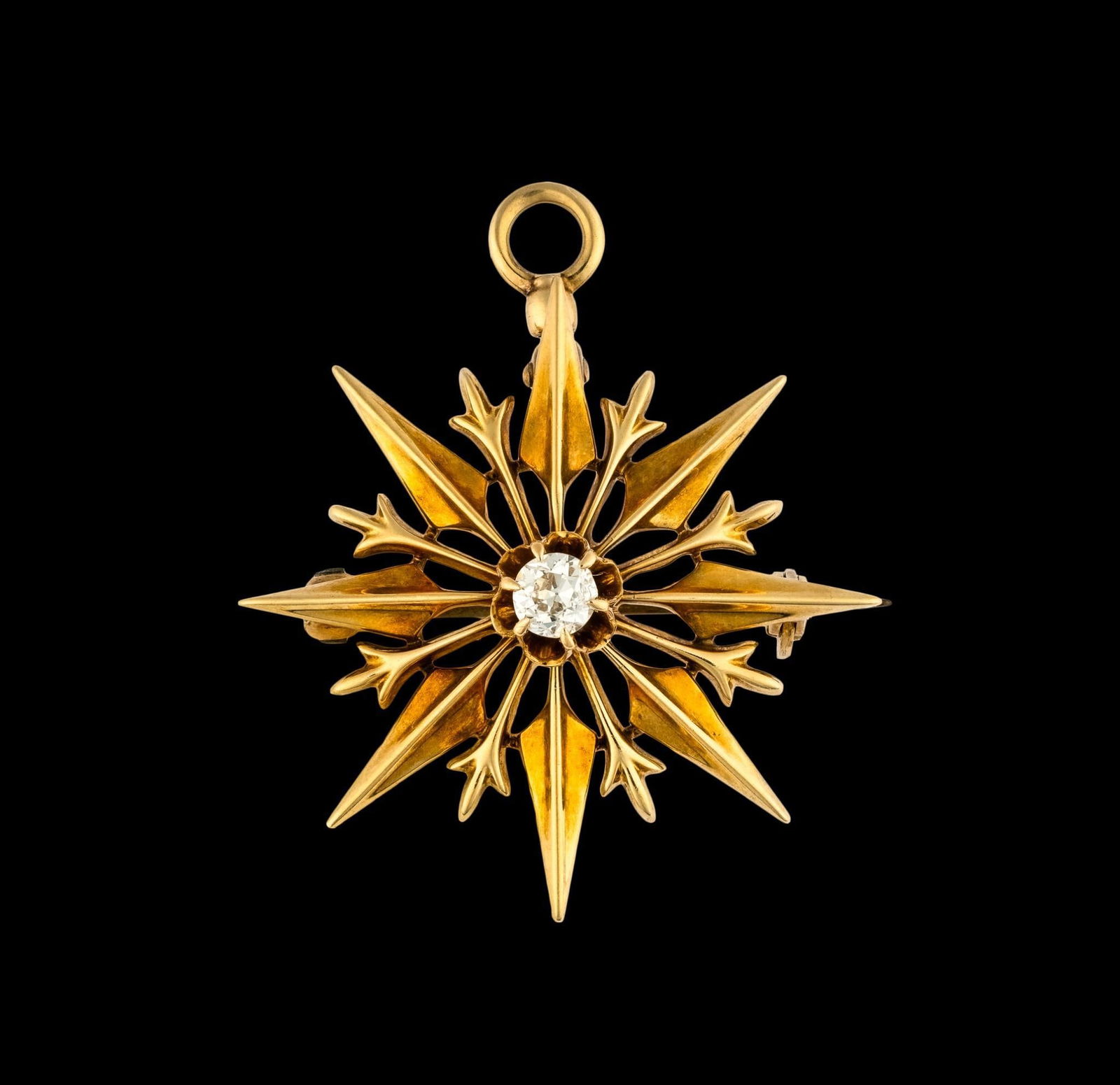 14K Gold and Diamond Pendant: A 1" width pendant or brooch with a 0.15 carat diamond in the center. The weight is 4.1 grams.