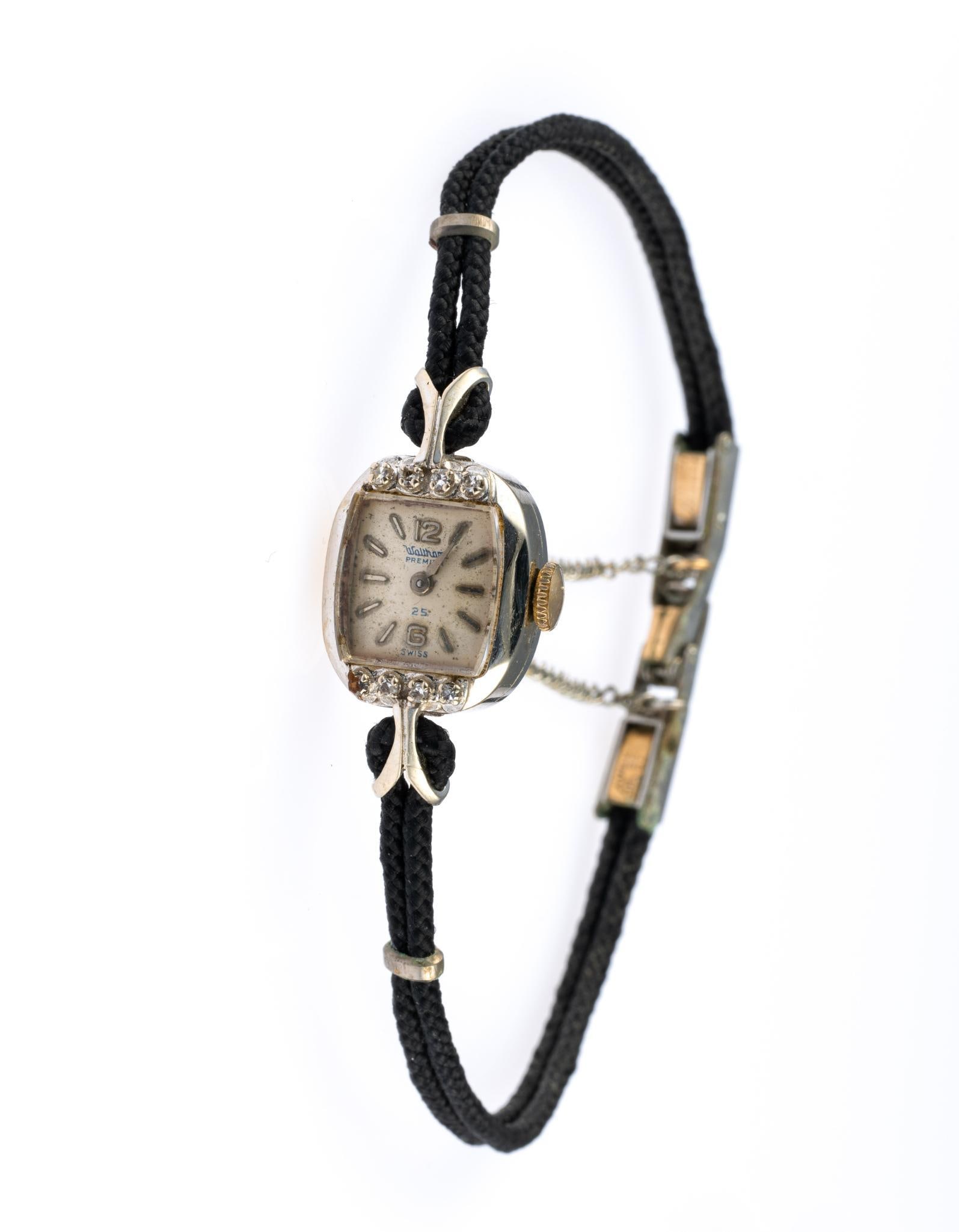 14K Gold Waltham Cord Watch: A white gold cased cord watch 14 mm width. The watch runs but has not been accuracy checked.