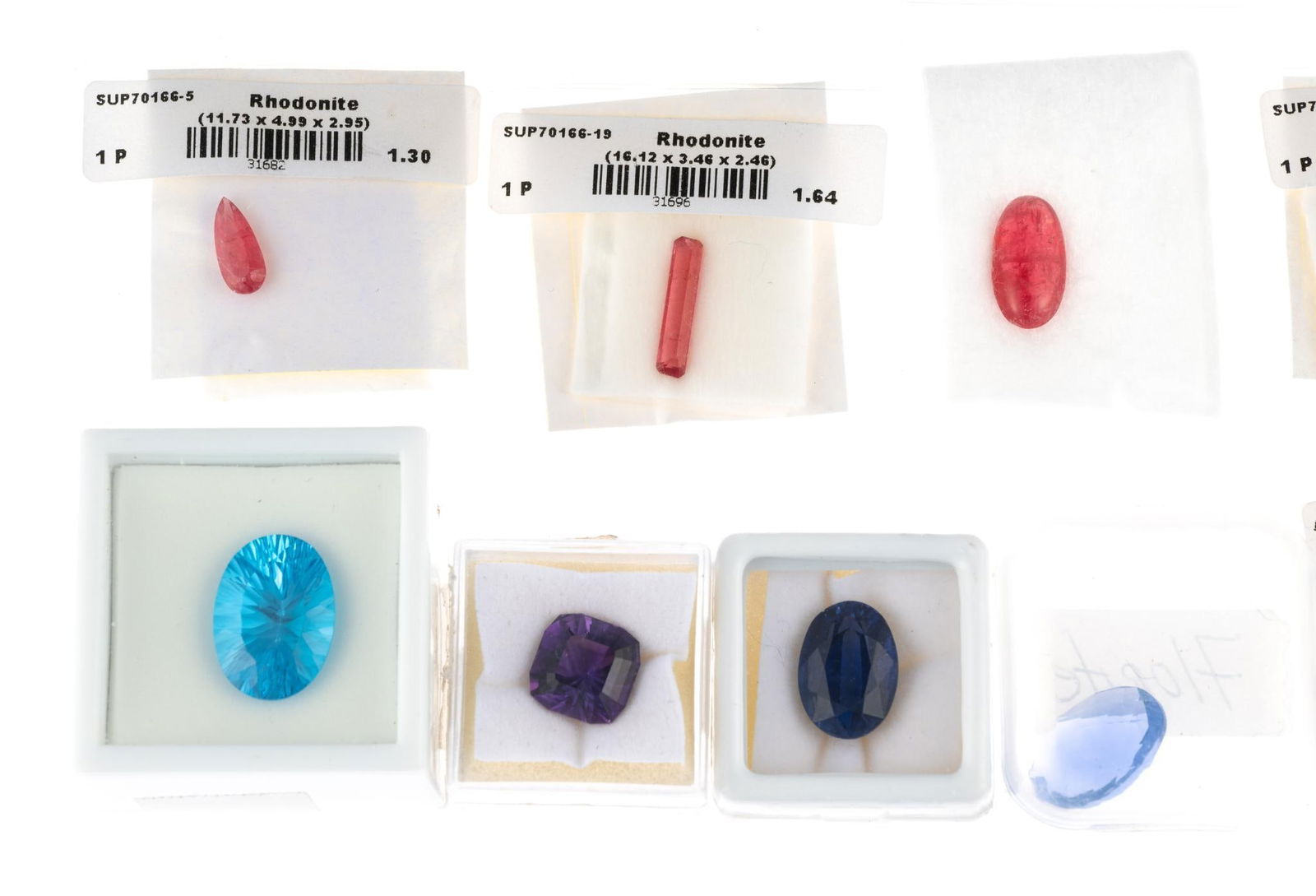 Ten Loose Gemstones: Unmounted gemstones include 12.7 carat topaz, 12.5 carat kyanite, 13.5 carat fluorite, 11.85 carat kunzite, 5.6 carat amethyst, (4) rhodonite gemstones, 7.65 carat maxixe beryl with lab report.