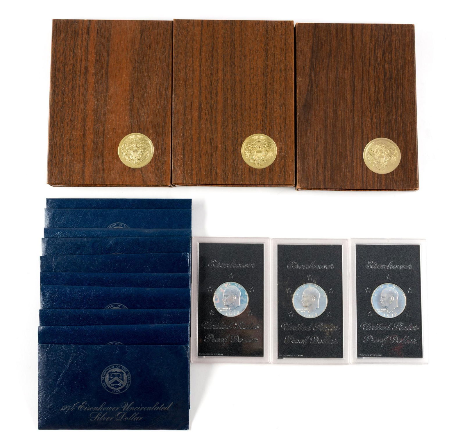 Sixteen Silver Eisenhower Dollars: Six are proof silver dollars of which three have boxes and three are in original acrylic holders. Ten are uncirculated silver dollars in the original packaging.