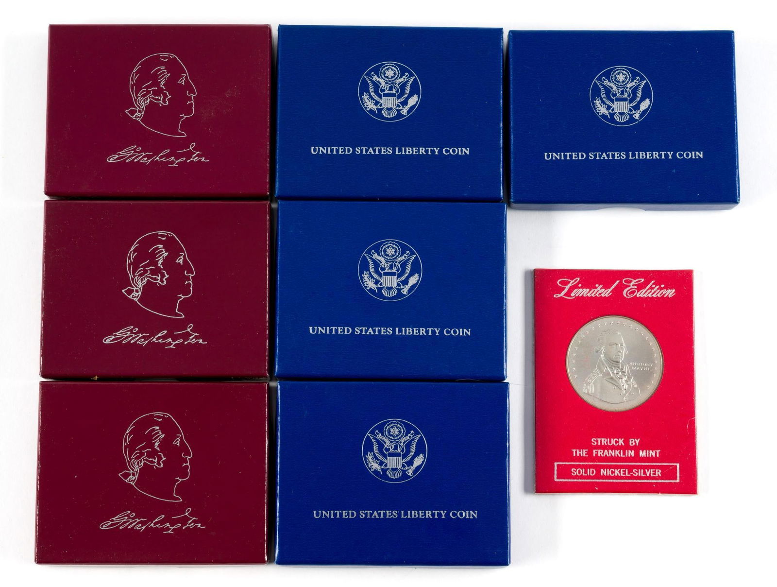 Commemorative Half Dollars Including Silver: Four United States Liberty half dollars of which two are silver. Three silver George Washington 1982 half dollars. One nickel silver Franklin Mint commemorative Michigan Centennial.