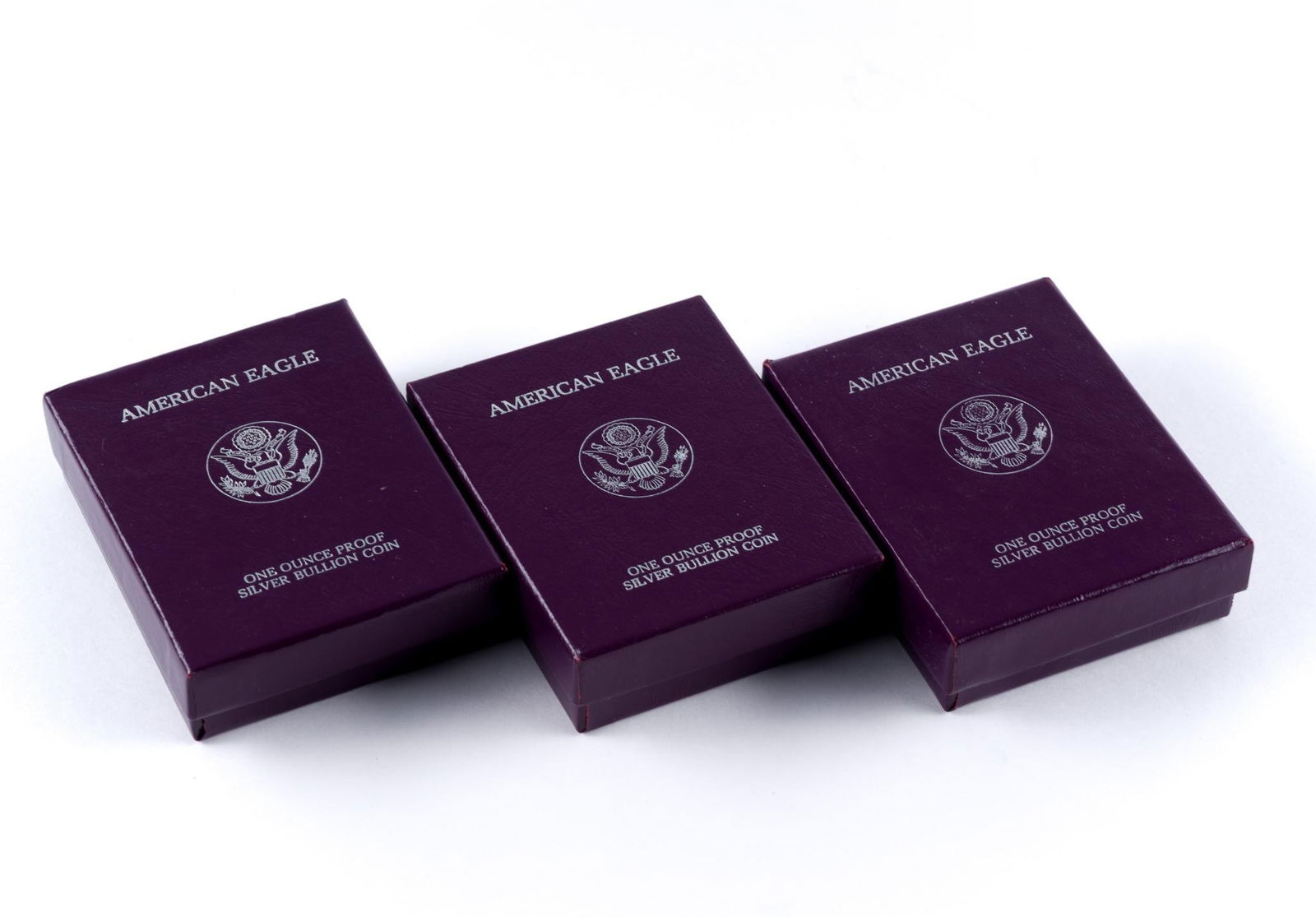 Three Silver Proof American Eagle Coins: The proof coins are 1886, 1988, 1989 with boxes and papers.