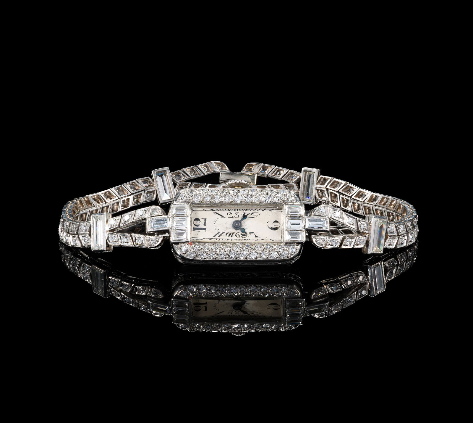 Agassiz Platinum and Diamond Wrist Watch: A diamond and platinum cocktail watch from the 1920's, Swiss watch maker Agassiz. The case and bracelet are set with 3.4 carats of baguette and round diamonds. The case and bracelet are both