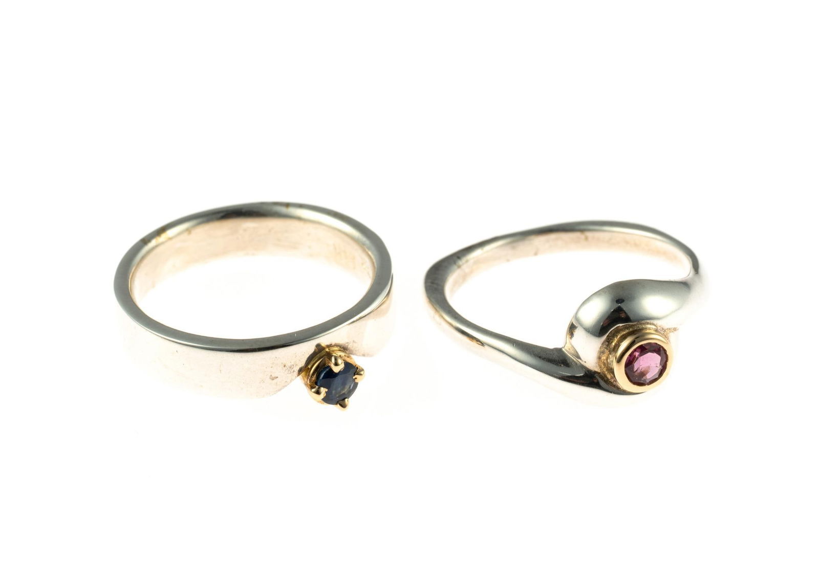 Two Sterling and 14K Gold Gemstone Rings: Both rings are sterling silver, size 6.25 to 7, one with blue sapphire and one with pink tourmaline mounted in 14k gold. Total weight is 7.7 grams.