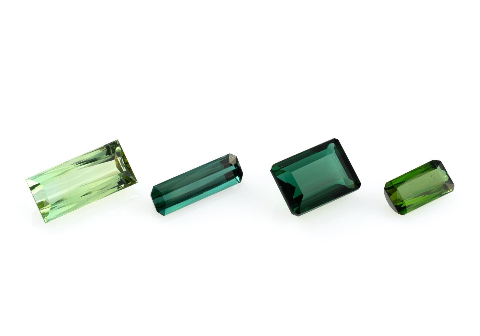 Four Tourmaline Gemstones: 9.29 carat light green baguette cut tourmaline, Afghanistan. 8.29 carat emerald cut chrome green tourmaline, Brazil. 4.13 carat octagon cut blue green tourmaline, Nigeria. 3.18 carat octagon cut