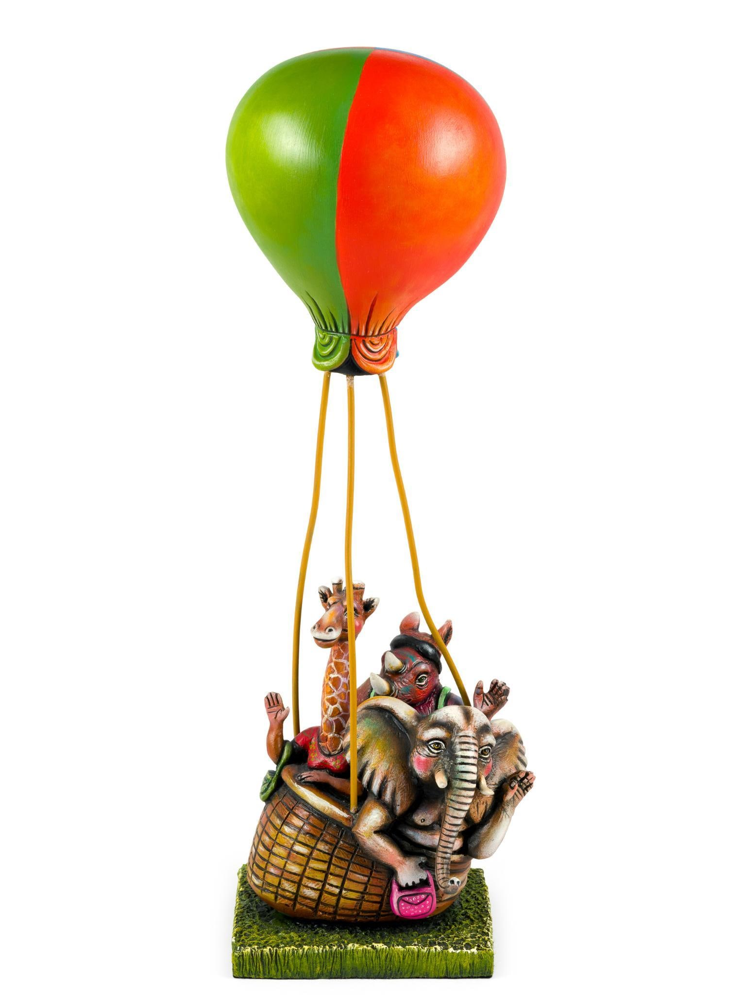 Carlos & Albert Hot Air Balloon Sculpture: A sculpture by Carlos Munoz and Albert Ickenroth depicting an elephant, giraffe, and rhinoceros in a hot air balloon. The height is 17 1/2" with width of 6". Number 61 of 150.