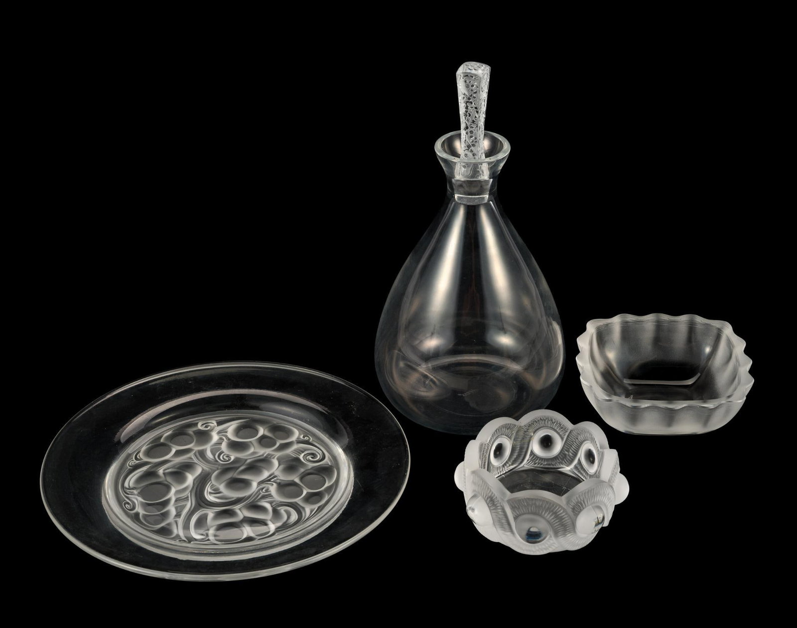 4 Pcs Lalique Glassware: Includes Phalsbourg decanter; Marienthal plate; Gao bowl; and fluted bowl. Decanter measures 5" wide x 9-7/8" high.
