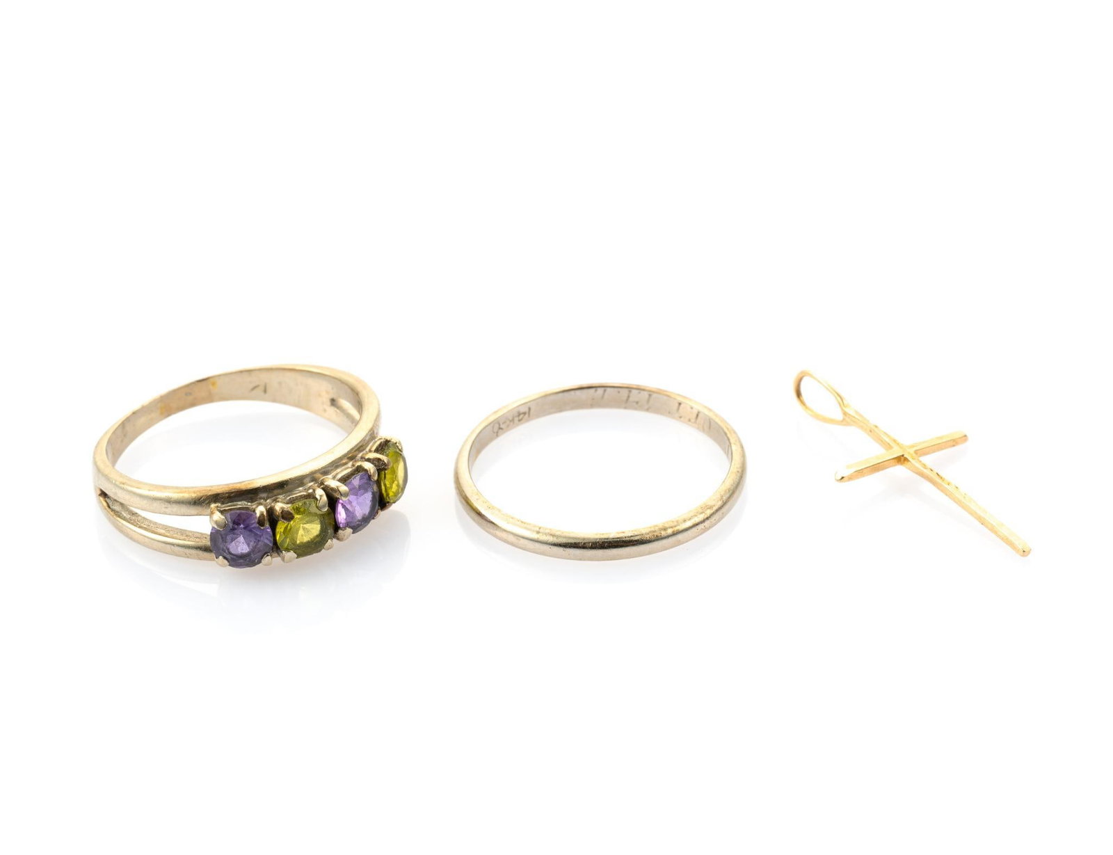 Two 14K Gold Rings and Cross Pendant: The rings are size 8.5 to 9 and are both 14k white gold, one with amethyst and peridot gemstones. Total weight of the three jewelry pieces is 6.2 grams.