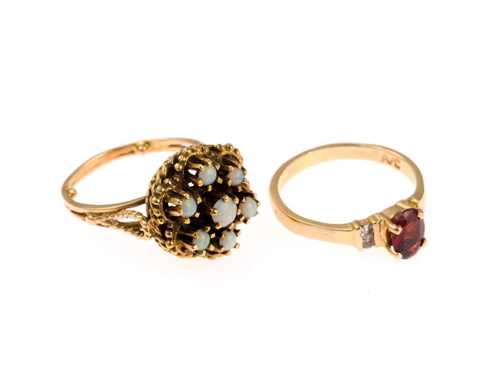 Two 14K Gold Rings: Two gemstone rings in yellow gold sized 5.5 to 6. One with seven cabochon opals and one with garnet and diamonds. Both test 14k gold and weigh 7.7 grams total.