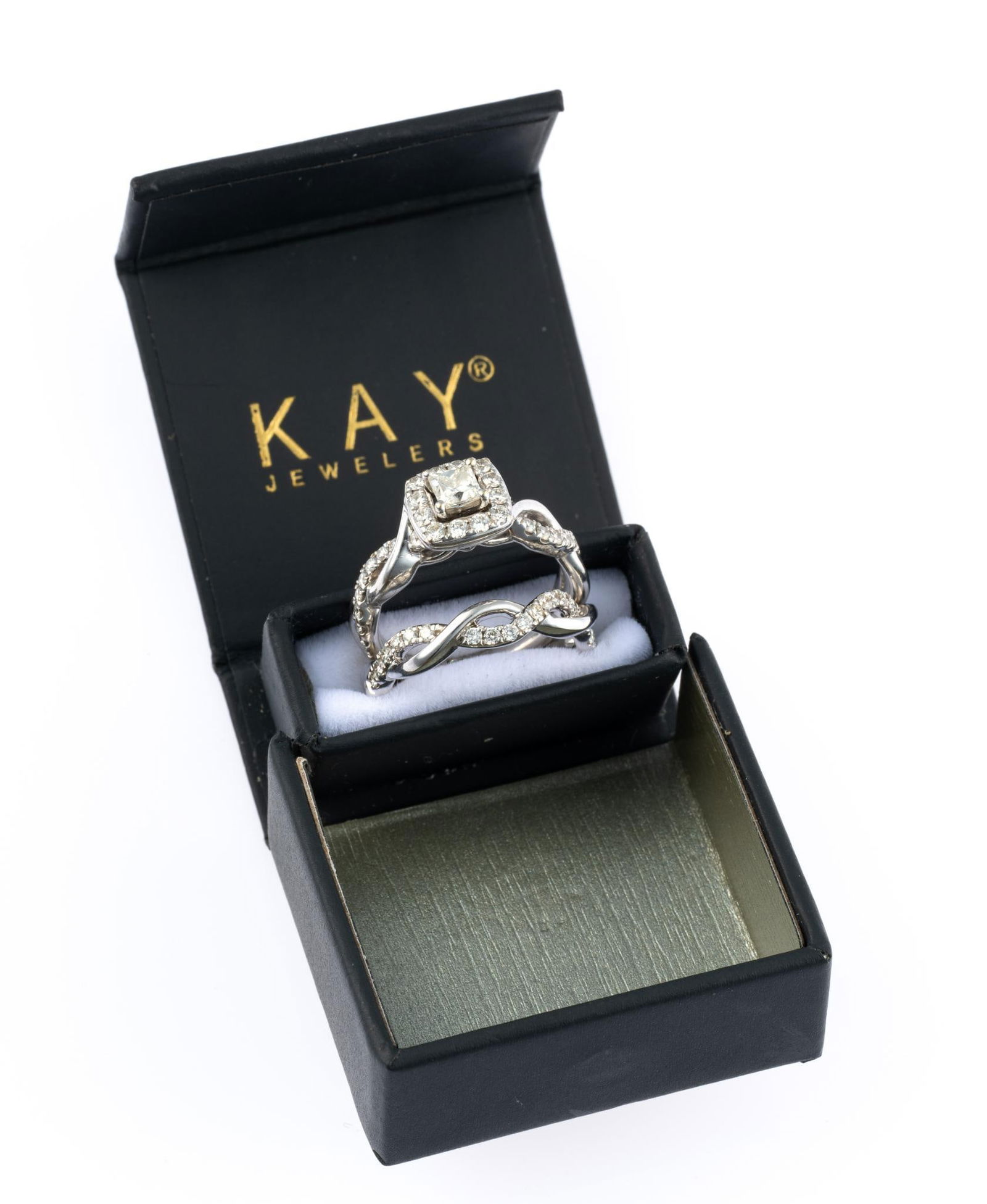 14K White Gold and Diamond "The Leo" Wedding Set: The engagement ring has a center diamond of approximately 0.3 carats, princess cut and is accented with small diamonds. The wedding ring nests with the engagement ring and has small diamonds to match.