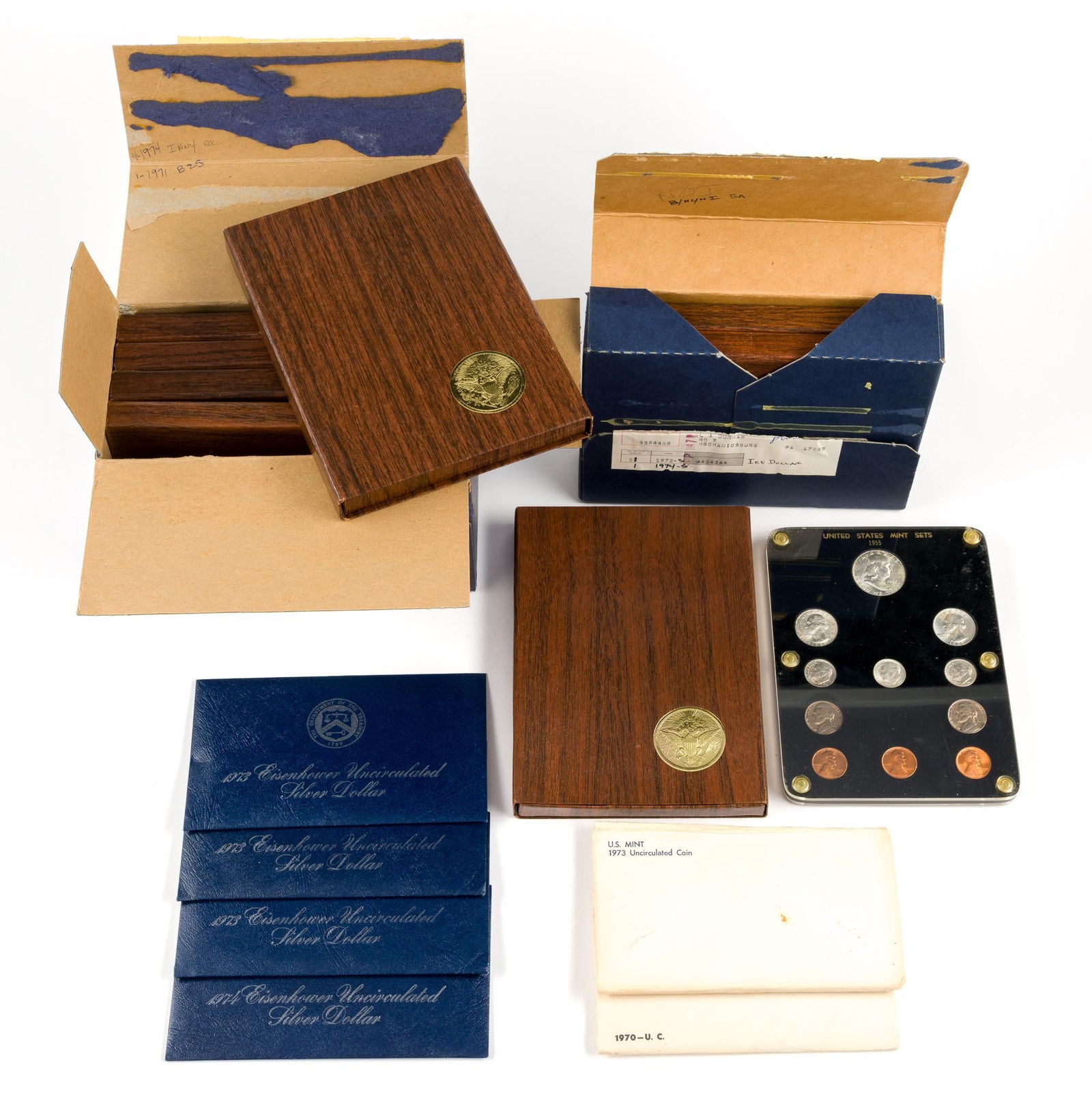 Silver Eisenhower Dollars and Mint Sets: Eight proof Eisenhower dollars, four uncirculated Eisenhower dollars, all silver. One acrylic holder 1955 mint set. Two non-silver mint sets.