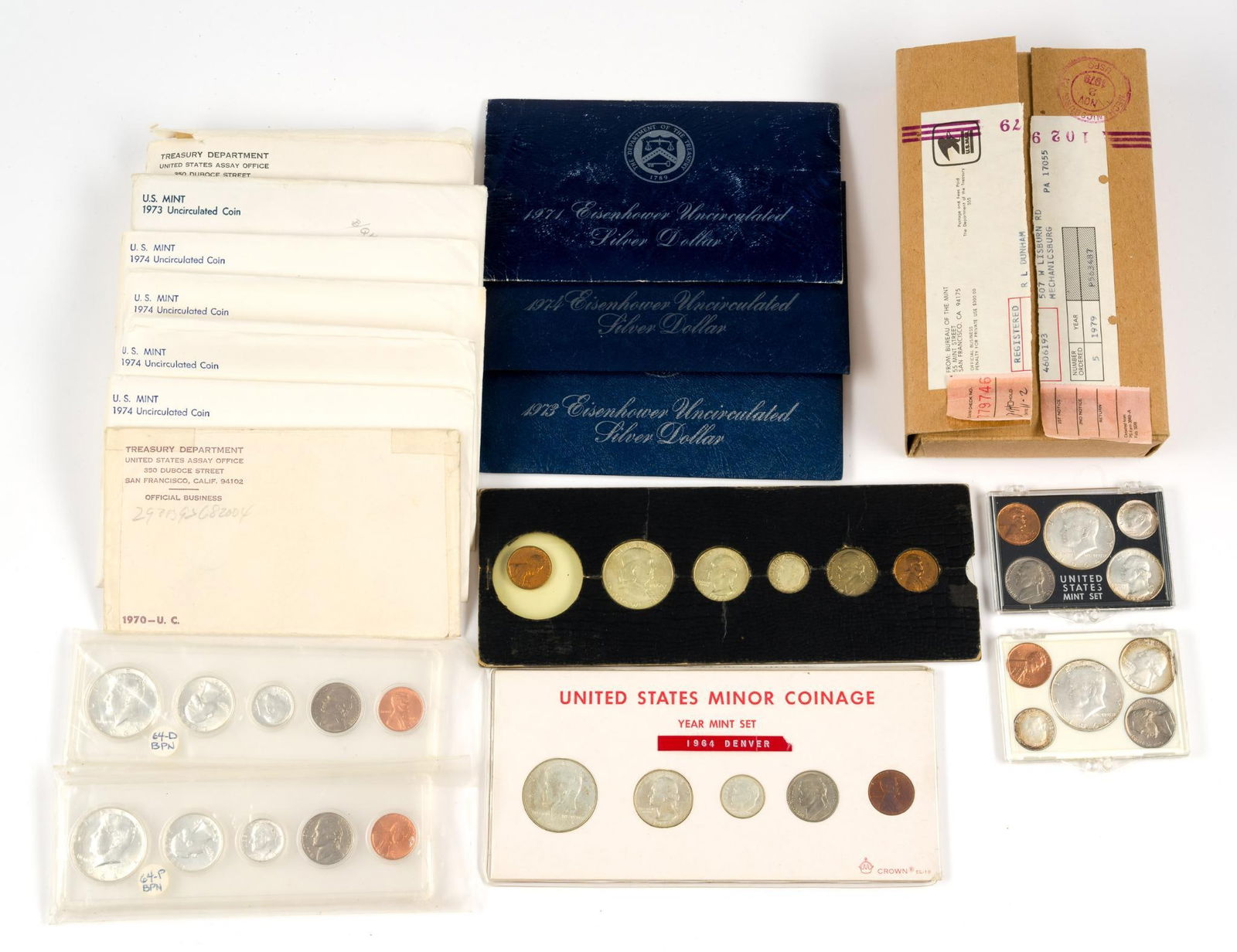 Mint Sets Including Silver and Silver Eisenhower Dollars: Twelve non-silver sets, six silver acrylic housed sets, three silver Eisenhower dollars.