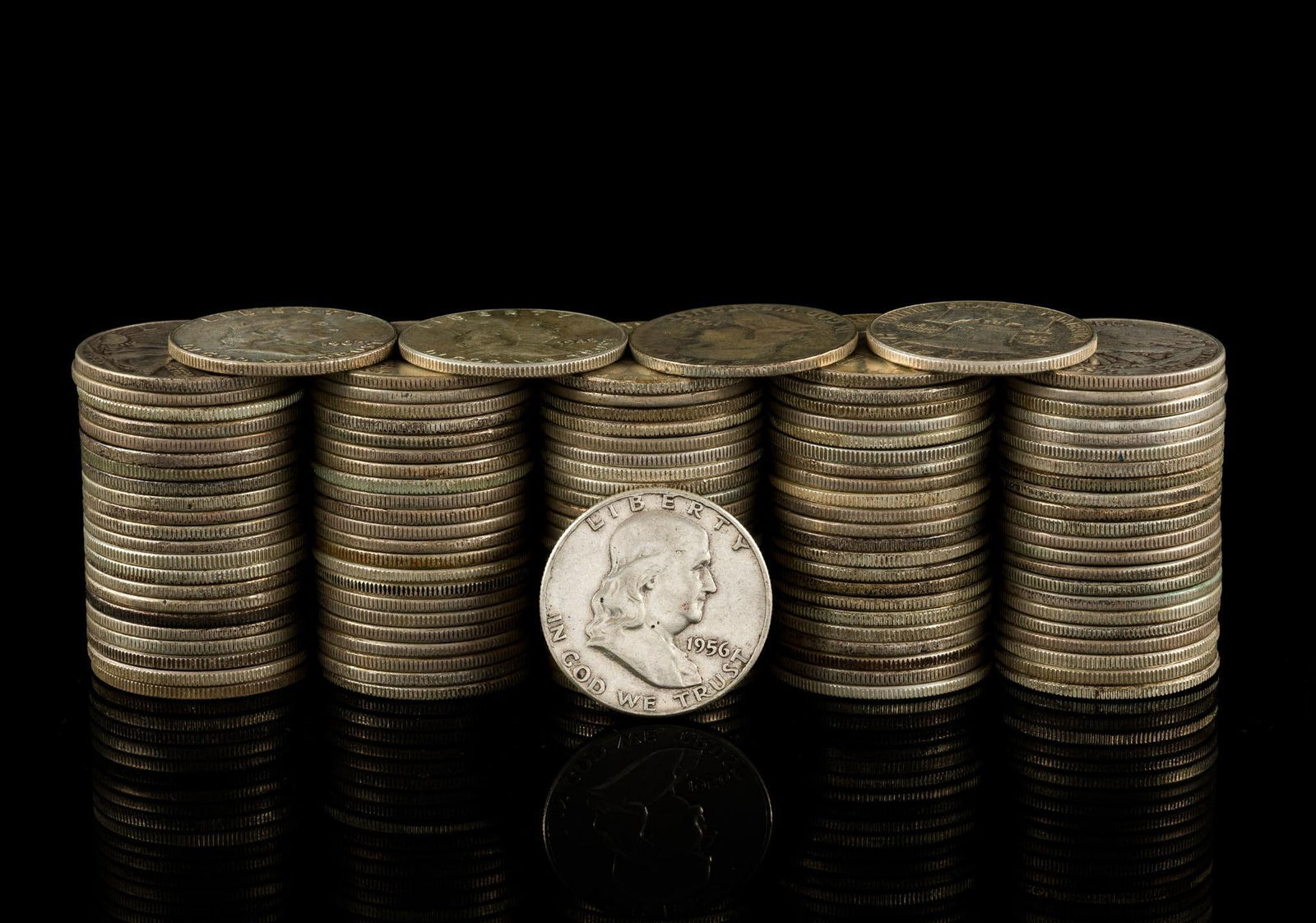 One Hundred Silver half Dollars: The lot is mixed Walking Liberty, Franklin, and 1964 Kennedy.