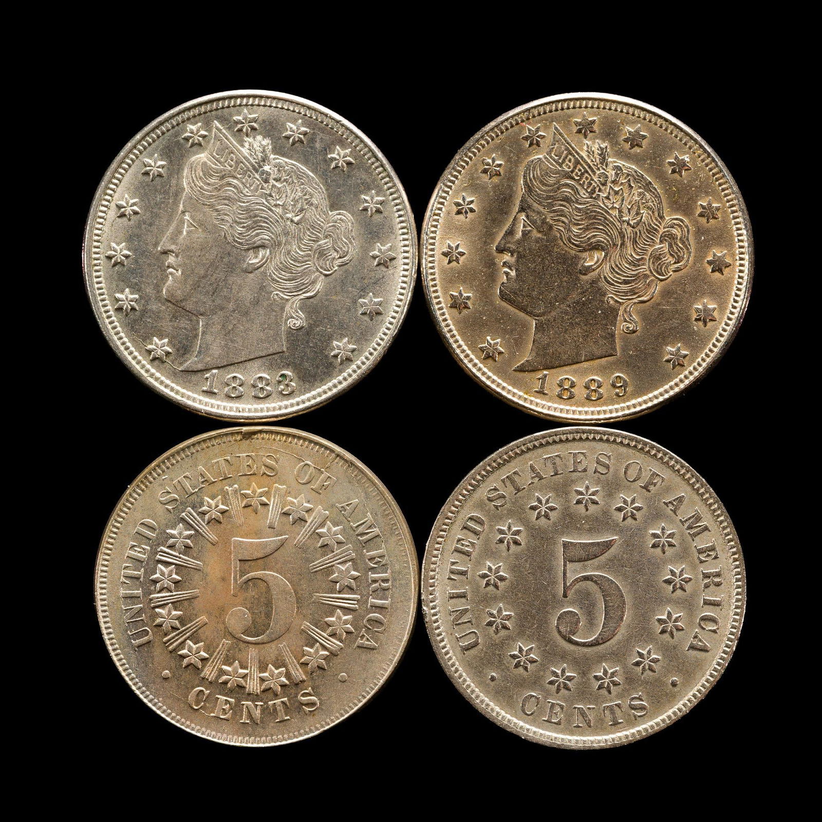 1867 Uncirculated Shield Nickel And V Liberty Nickels: 1867, 1883, 1883 No Cents, 1889. The 1867 has numerous die cracks, one impeding the strike of the 67. The coin is in an upper uncirculated grade with no surface problems and with rainbow toning. From