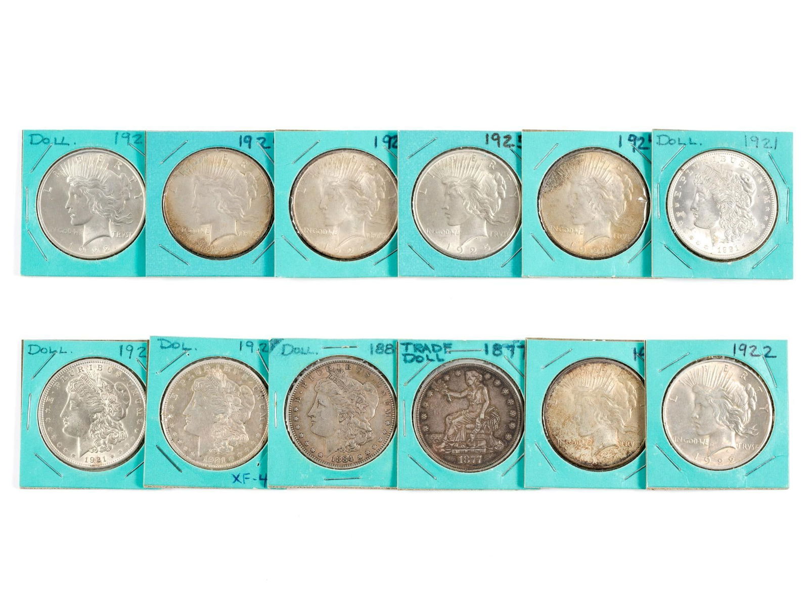 Twelve Silver Dollars Including 1877 Trade Dollar: 1877 Trade Dollar with good surfaces, not past cleaned, XF. Four Morgan dollars and seven Peace dollars