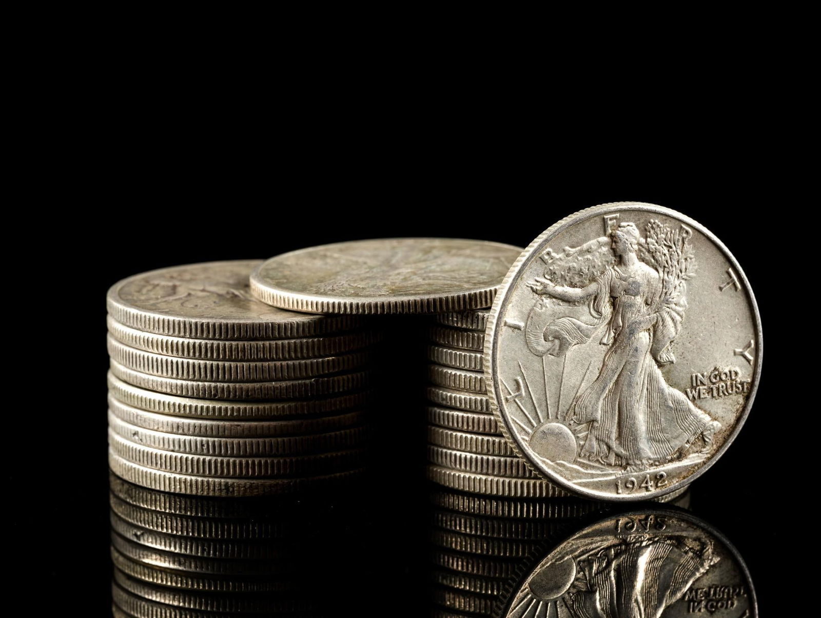 Twenty Silver Walking Liberty Half Dollars: Earlier coins have substantial wear while later coins may be AU or uncirculated.