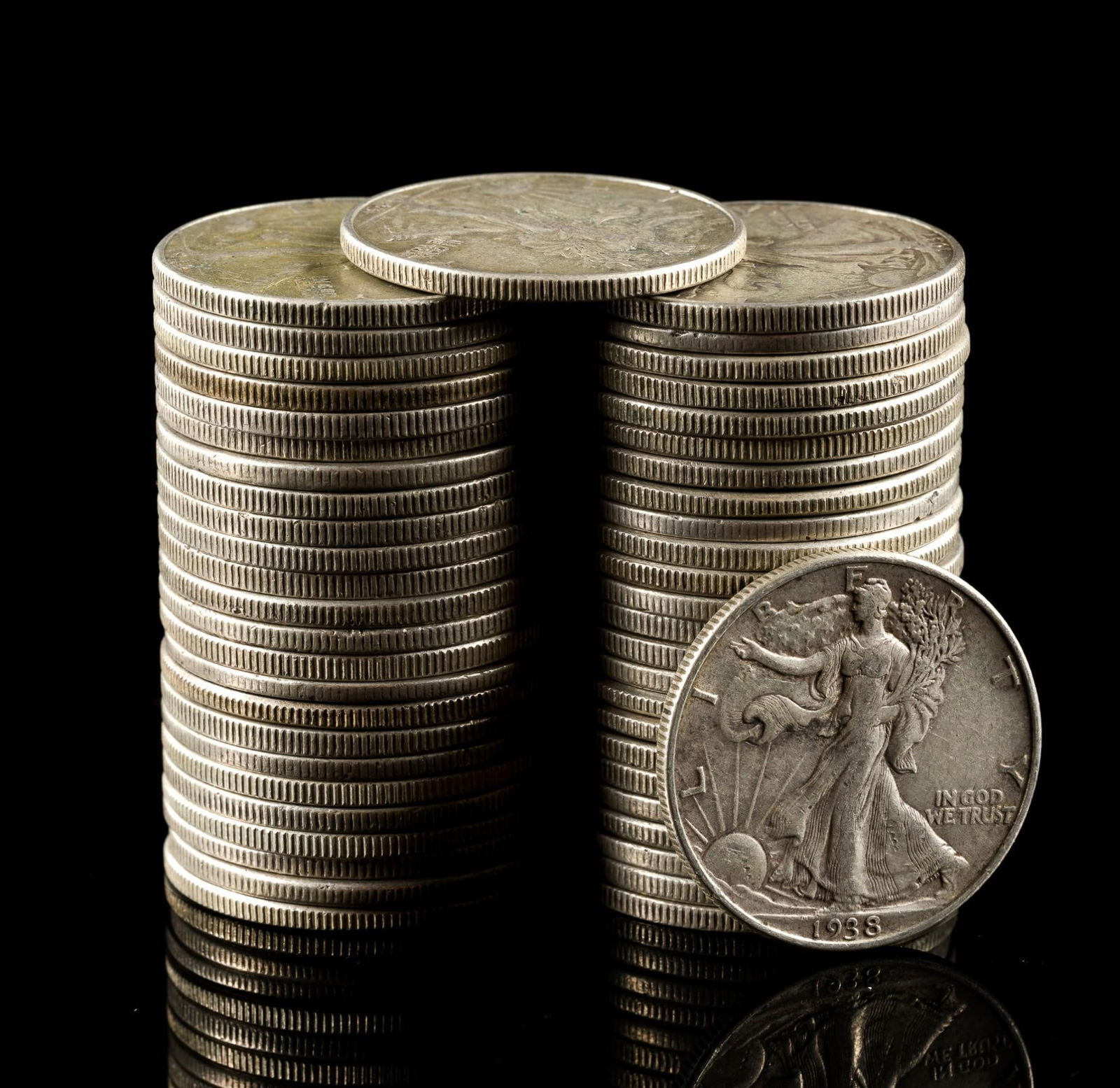 Fifty Silver Walking Liberty Half Dollars: Earlier coins have substantial wear while later coins may be AU or uncirculated.