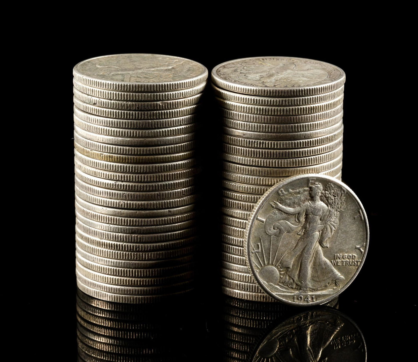 Fifty Silver Walking Liberty Half Dollars: Earlier coins have substantial wear while later coins may be AU or uncirculated.