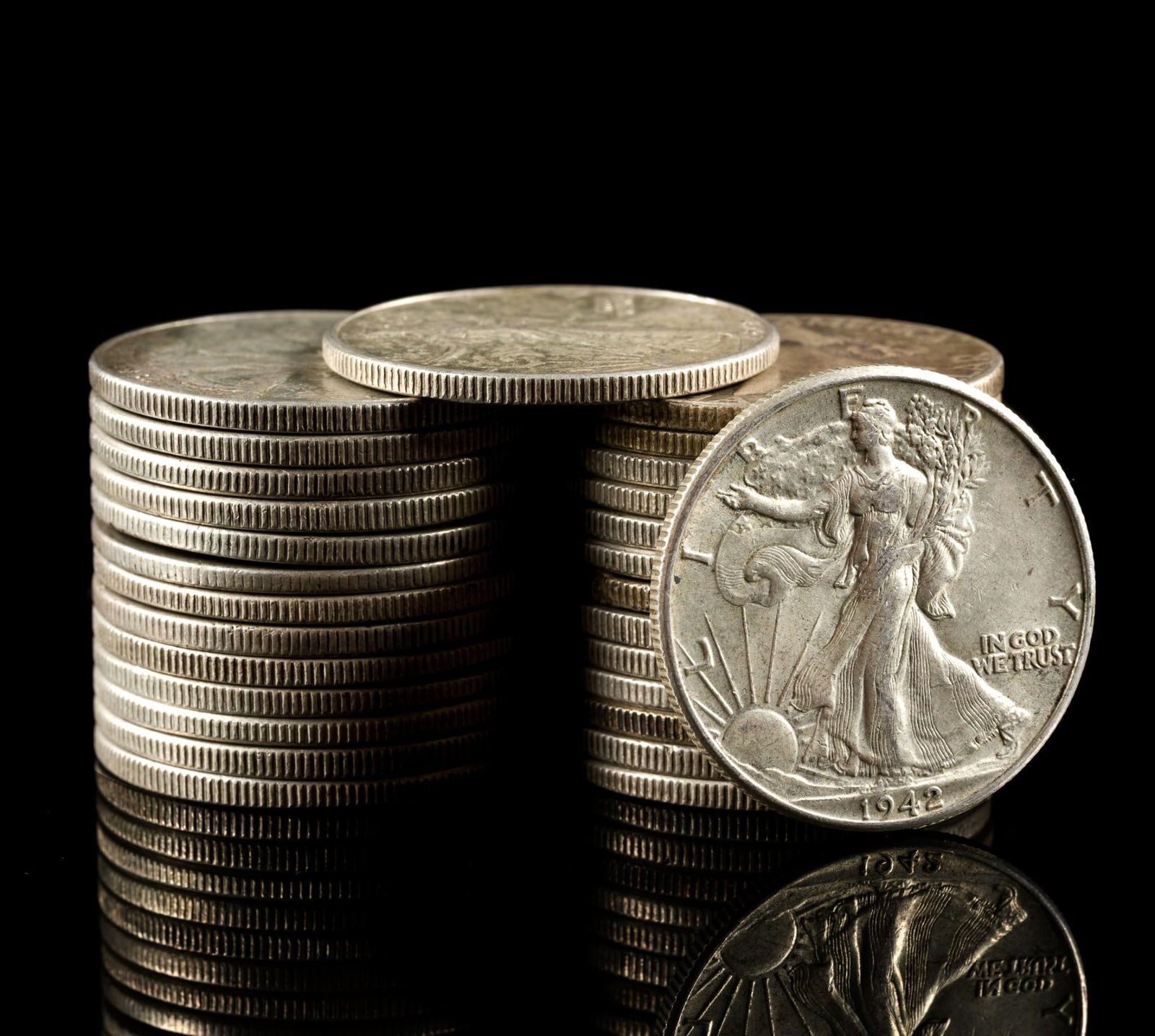 Twenty Eight Silver Walking Liberty and Franklin Half Dollars: Earlier coins have substantial wear while later coins may be AU or uncirculated. Four of the halves are Franklin and the remainder are Walking Liberty.