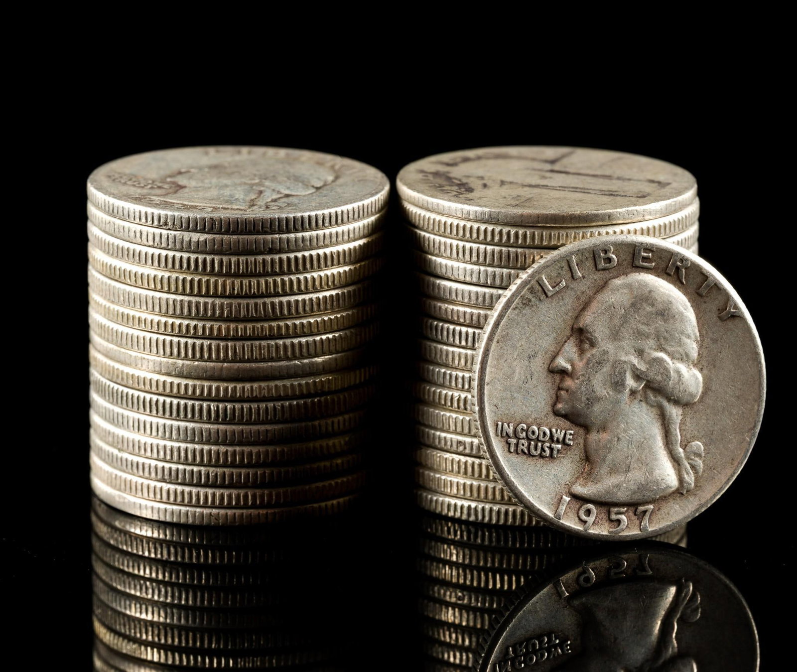 Thirty One Silver Quarters: One of the coins is a worn no-date Standing Liberty quarter and the remainder are 1964 or earlier Washington quarters.