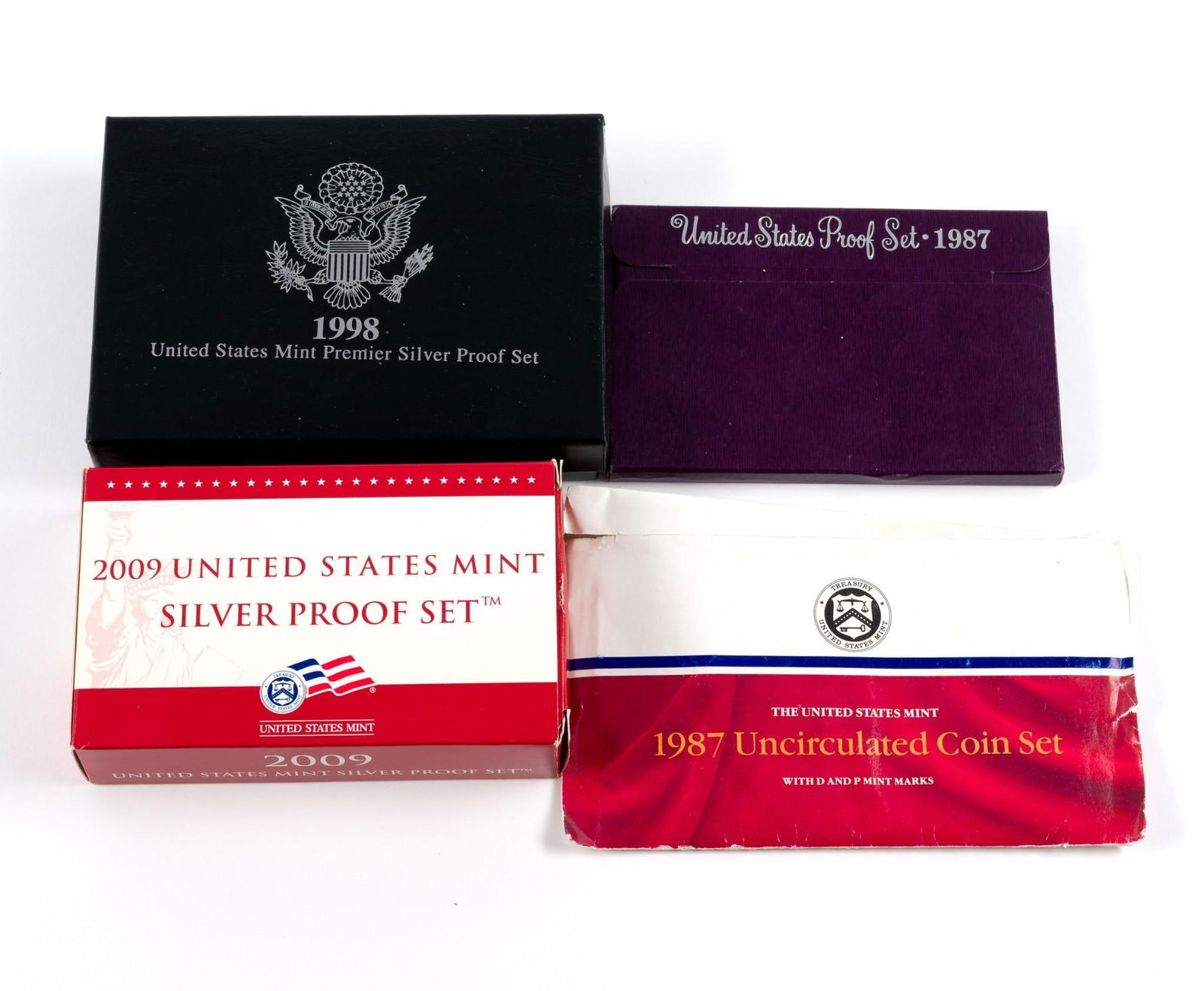 United States Proof Sets Incl. Silver: 2009 silver proof set which contains five silver U. S. Territories quarters and five golden dollars (non-gold) as additional coins to typical earlier proof sets, 1998 Premier Silver Proof Set, 1987