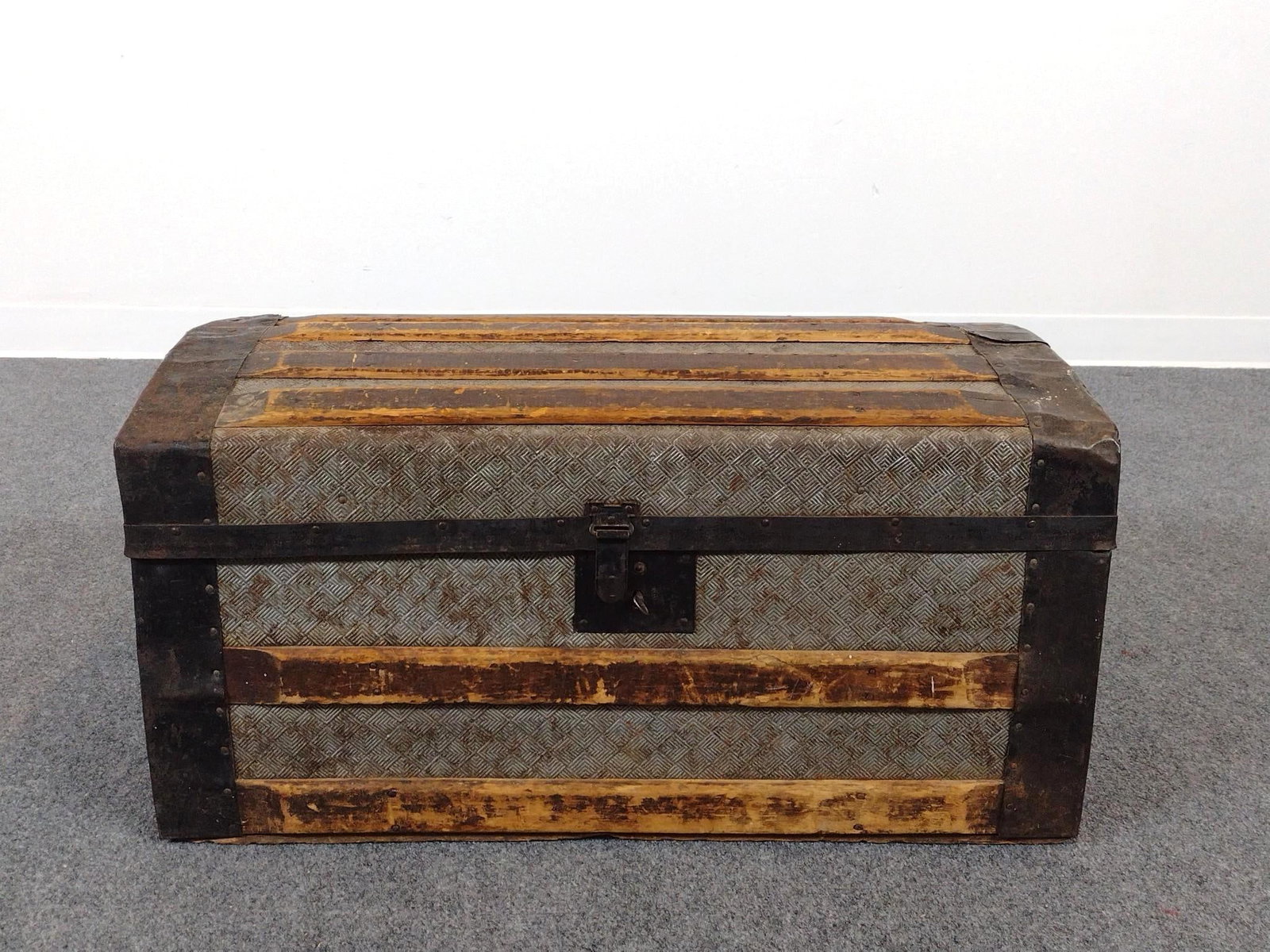 Steamer Trunk: 28" wide X 15-1/2" deep X 14-1/4" high. Has finish loss and rust.