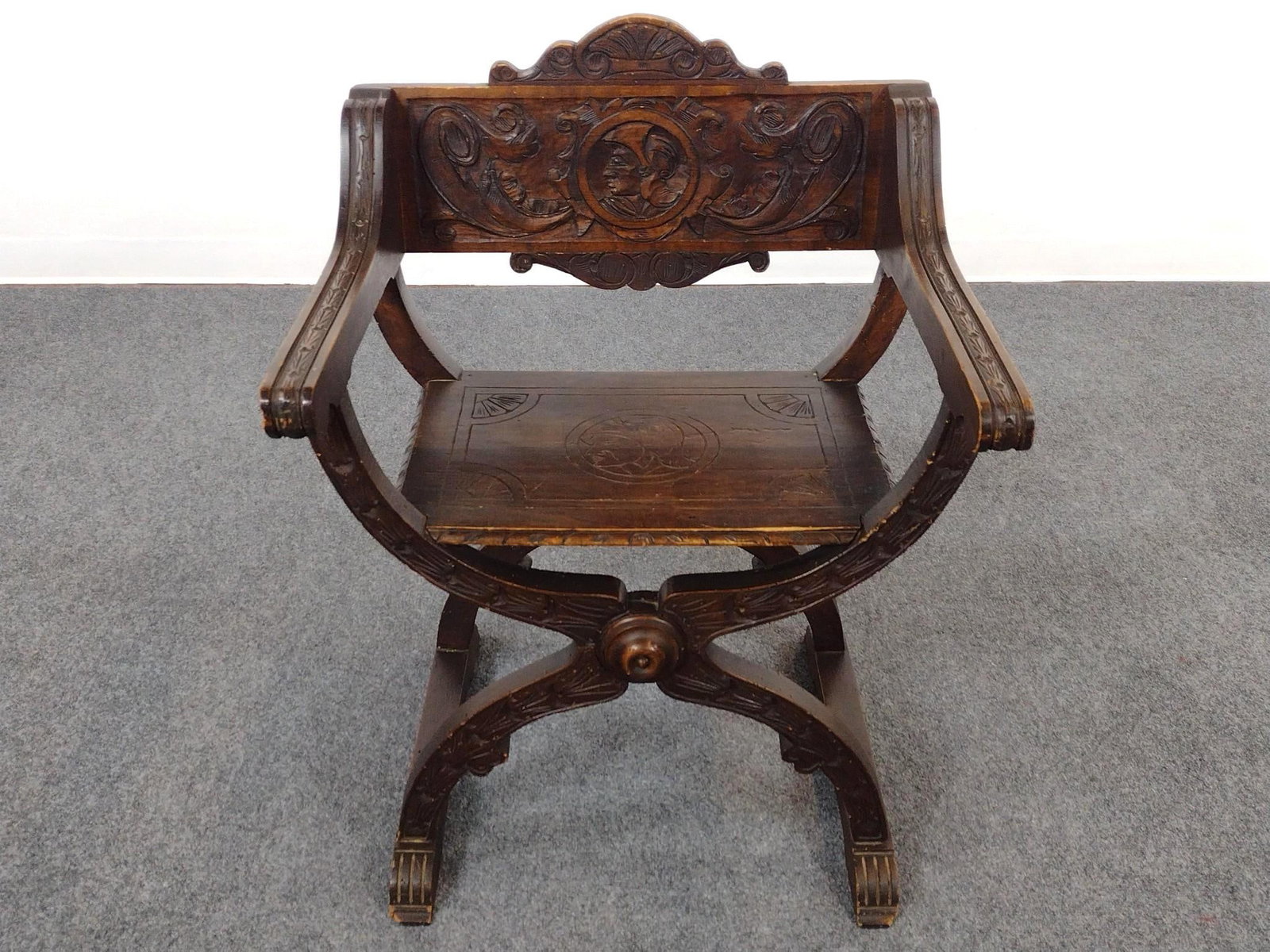 Savonarola Style Carved Arm Chair: 24-3/4" wide X 20" deep X 33" high. Has some scratches and areas of finish loss.