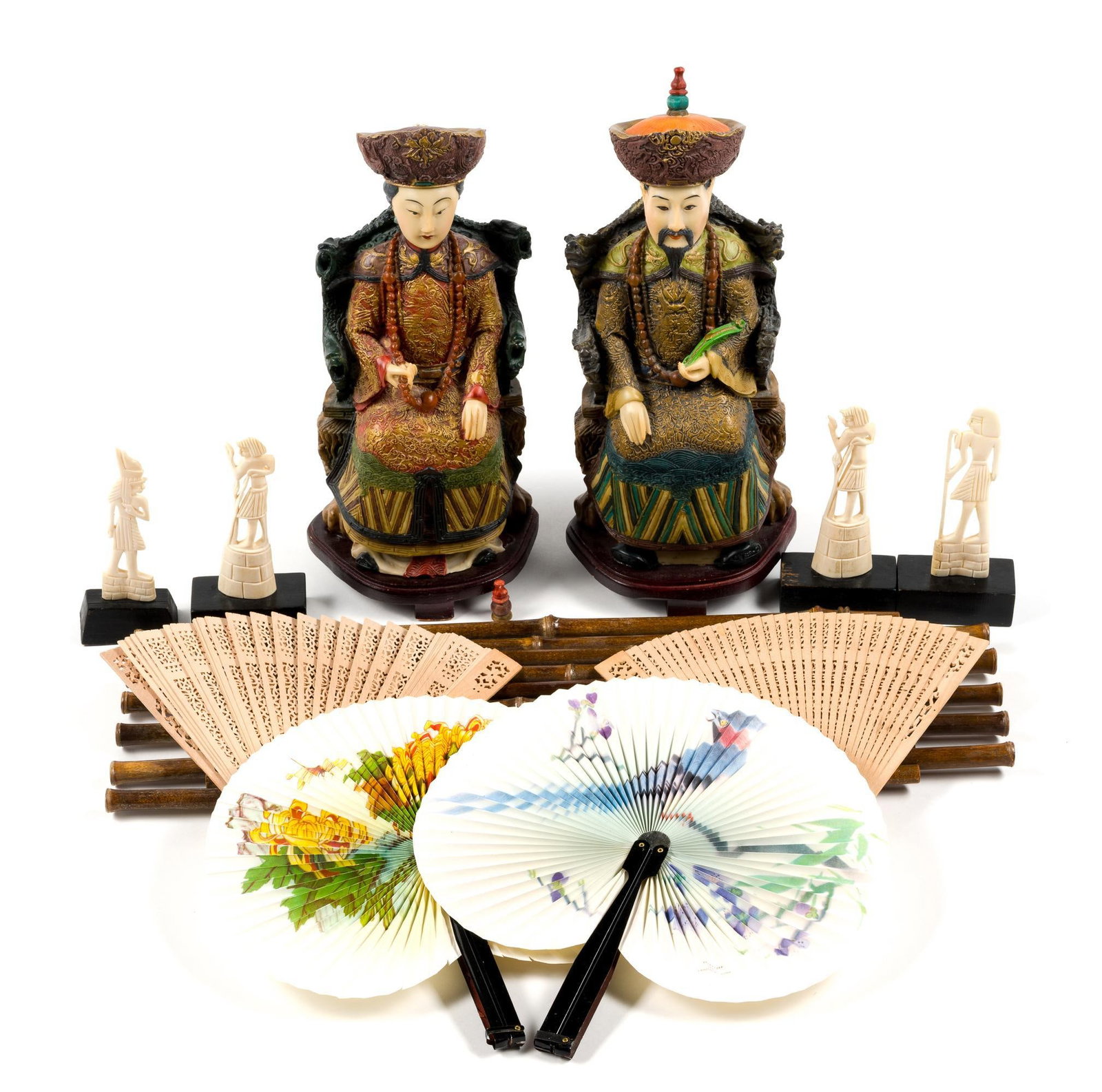 Asian And Egyptian Decorative Pieces: Includes Emperor and Empress statues. Statues are 13" tall and 5" wide, the Empress statue was repaired at the base and on the top of the head. Also includes two paper and two wooden fans, a 20" long