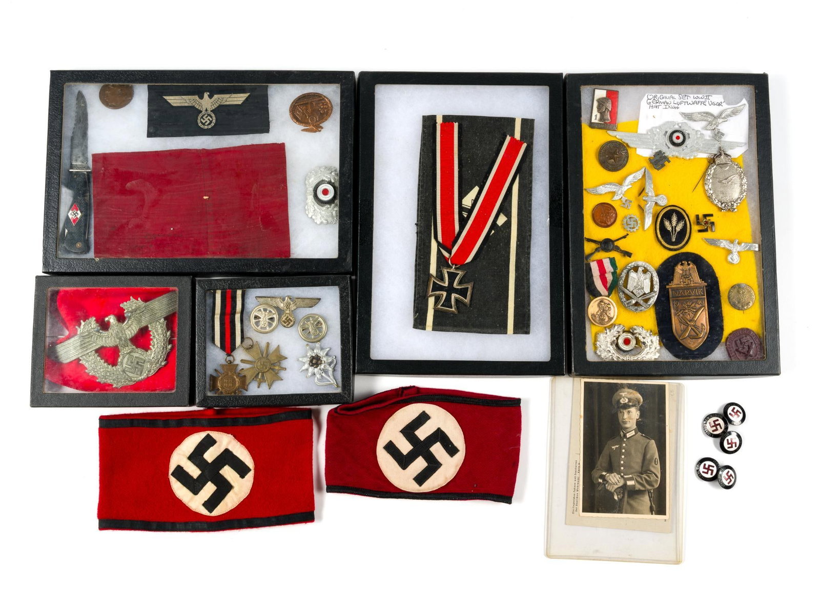 German WWII Memorabilia: Includes knife, pins, arm bands, insignia, and medals. Box sizes are 8 - 1/2" wide by 12 - 1/2" deep and 1" high.