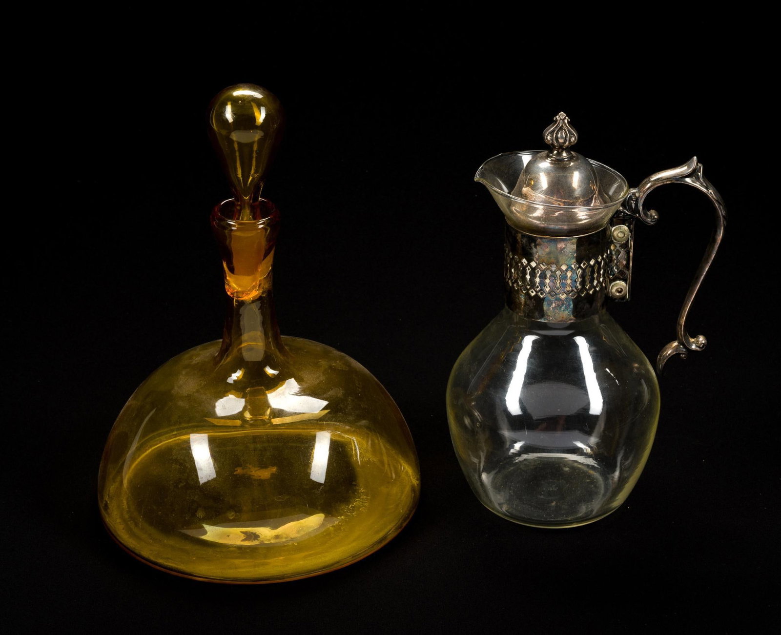 Vintage Amber Glass Decanter & Silver Plated Glass Carafe: Some small internal cracking on the neck of the decanter. Decanter measures 8 - 1/2" x 11 - 1/2", carafe measures 6" x 10".