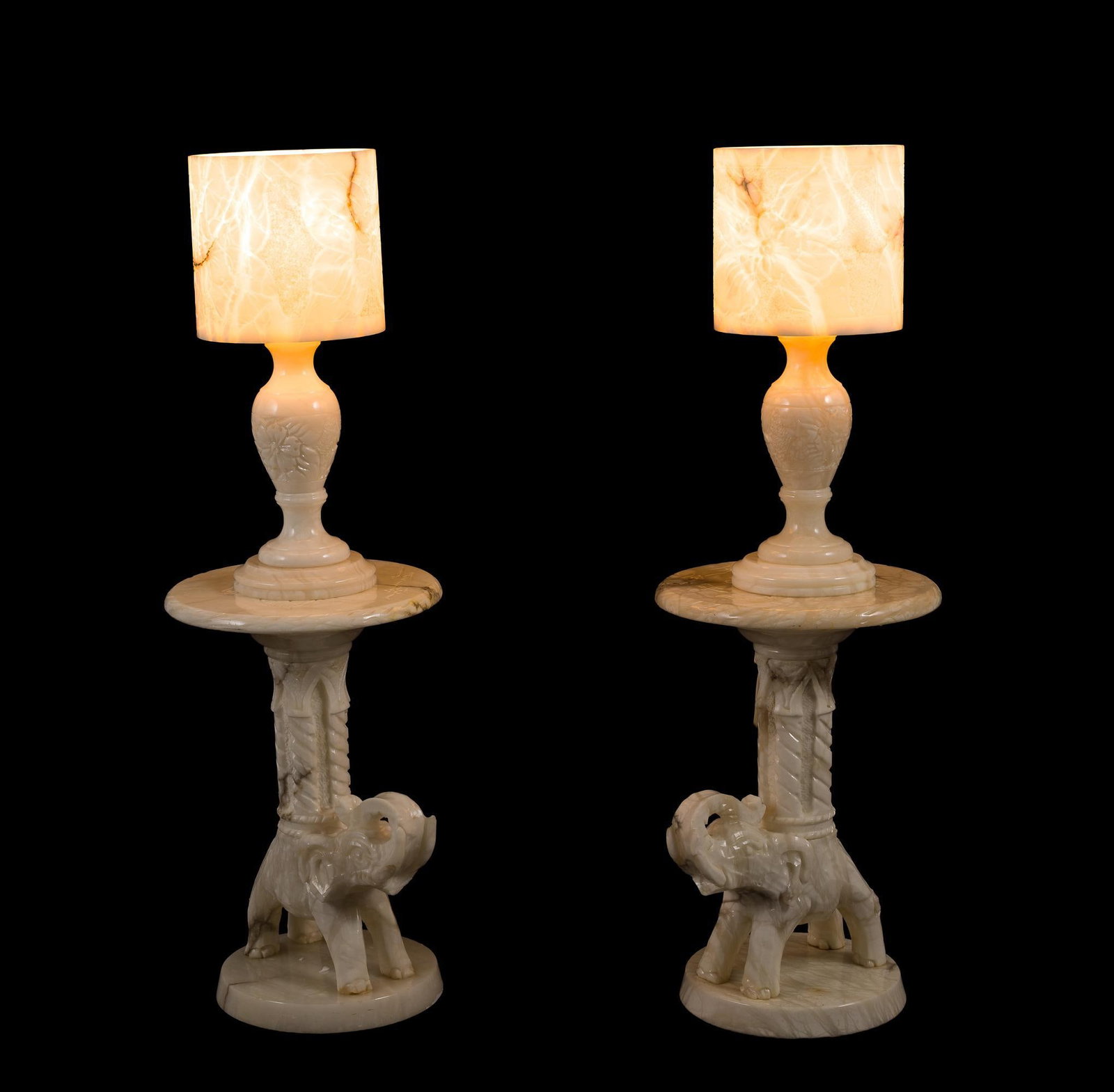 Pair of Carved Italian Marble Elephant Tables w/ Lamps: NOT ELIGIBLE FOR IN-HOUSE SHIPPING: See Terms for Shipping Options. Working. Base with carved elephant figure. Overall 14-1/2" wide x 44-1/2" high.