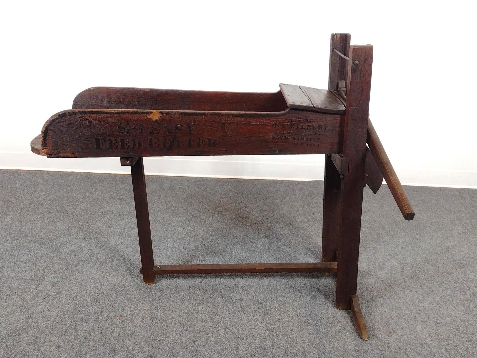R.S. Gilbert Feed Cutter: Vintage feed cutter or corn fodder cutter, a 19th-century agricultural tool used to chop cornstalks, hay, or straw into small pieces for livestock feed. 32" wide X 46" deep X 36" high. Has wear