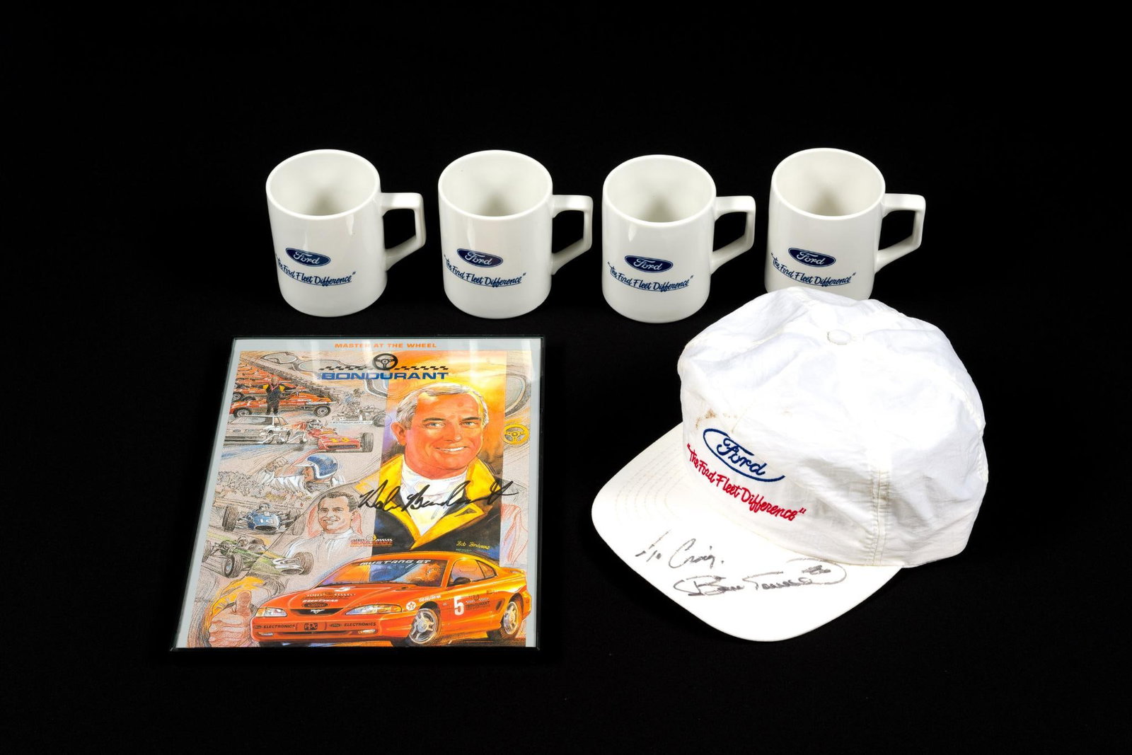 Signed Bob Bondurant Poster and Hat & Ford Mugs: Poster is framed and measures 11 - 1/8" x 8 - 5/8".