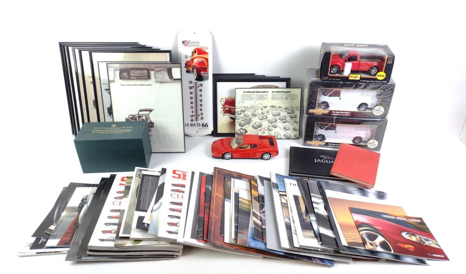 Automotive Memorabilia: Includes automotive pamphlets, 4 metal model cars, 3 in the box and one not in a box, a Route 66 thermometer, and framed images of automotives.