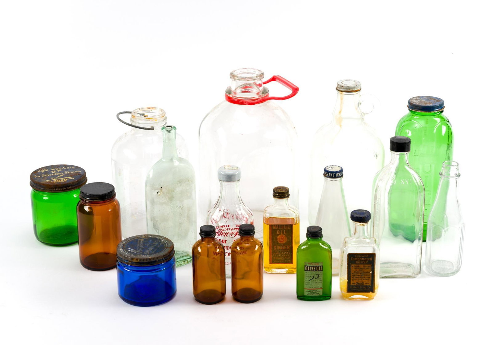 17 Antique Bottles Incl. McKesson's & Singer: Largest bottle measures 6" x 11" x 6".