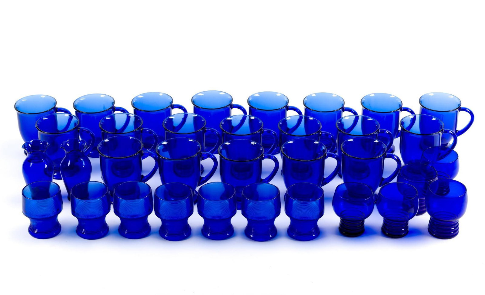 3 Sets of Cobalt Blue Glasses: 3 distinctly different style blue goblets. Largest glass measures 5 - 1/2" x 5" x 4".