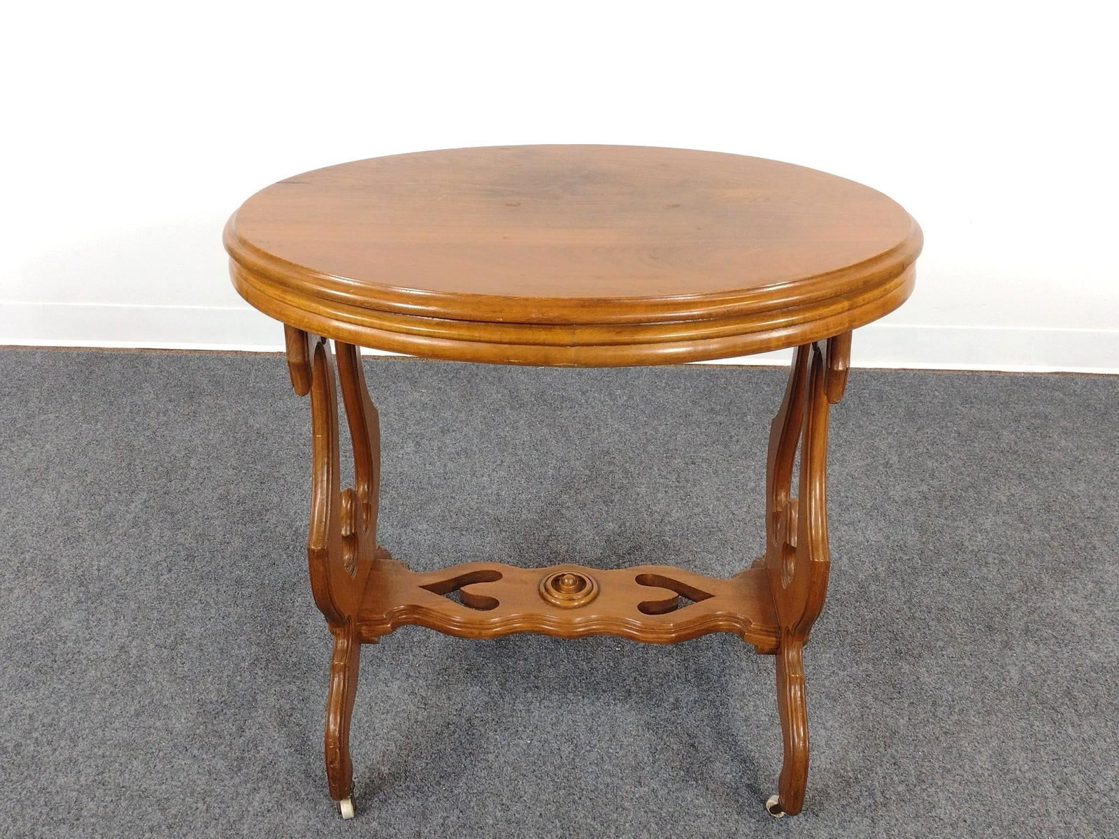 Oval Top Occasional Table: Carved lower stretcher. 40" wide X 20-1/2" deep X 29" high.