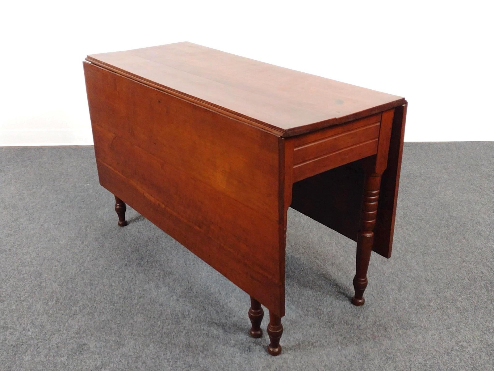 American Sheraton Cherry Drop Leaf Table: Open 61-1/4", closed 20-1/4" wide X 46-1/2" deep X 29-3/4" high. Has a few light scratches.