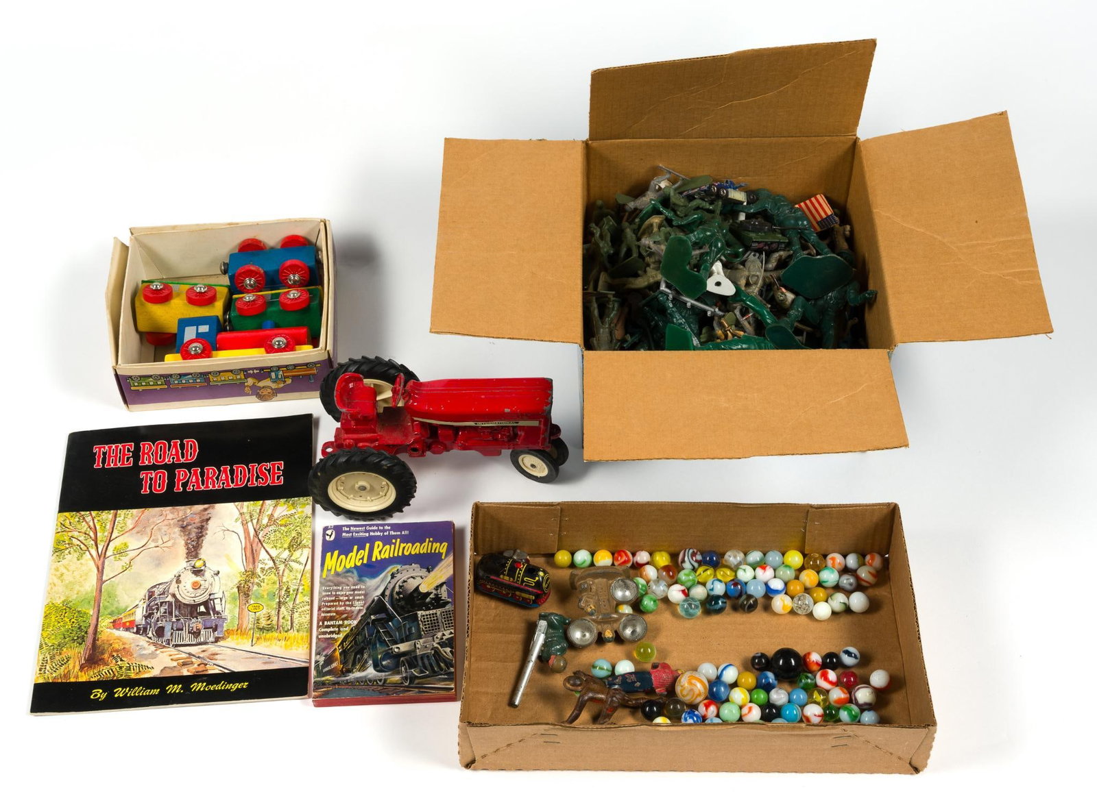 Vintage Toys: Includes green plastic army men, 2 books about model trains, marbles, a metal tractor and wooden train. Red tractor measures 8 - 1/4" x 4 - 1/2" x 4".